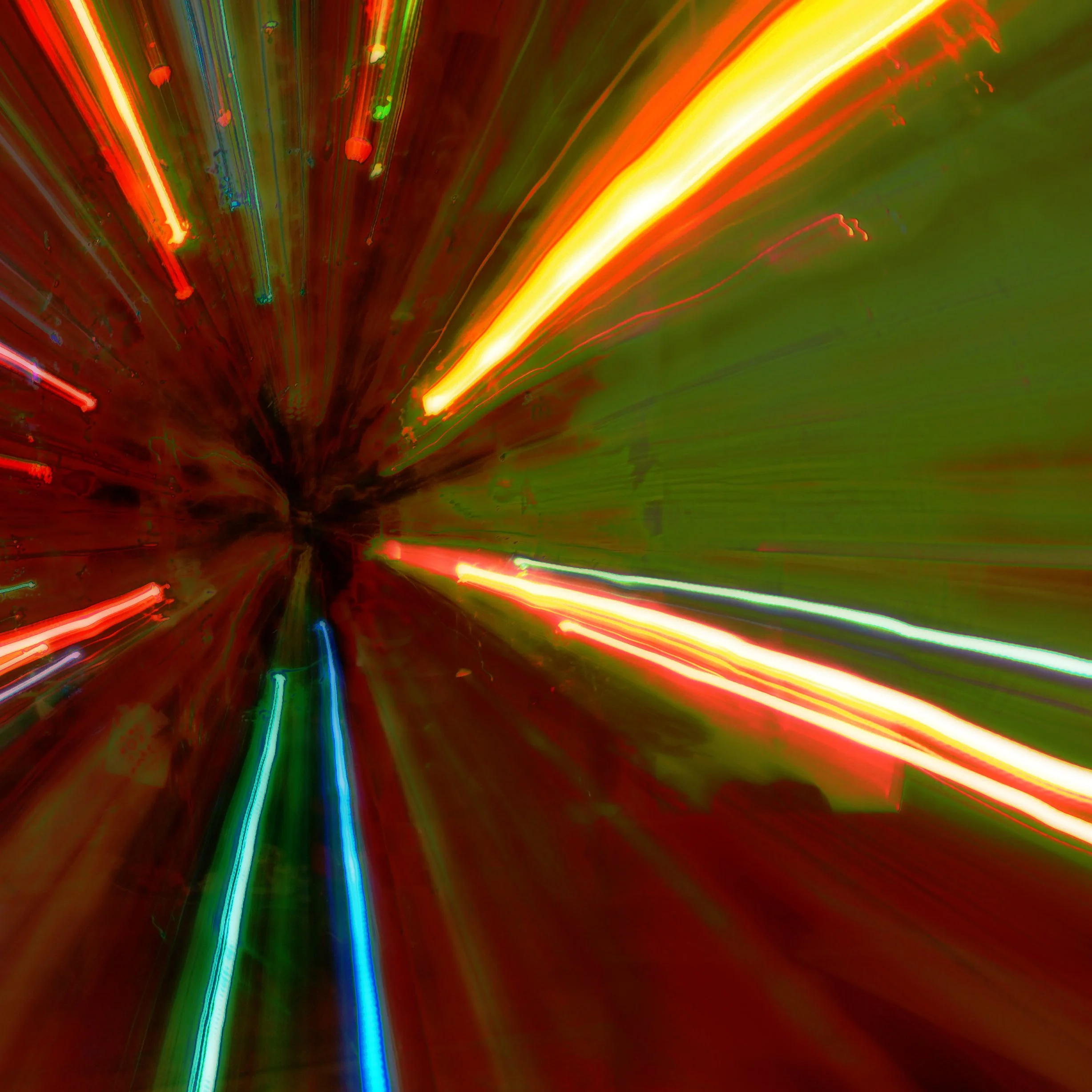 Abstract image with vibrant red, yellow, and green light streaks creating a dynamic, radial pattern.