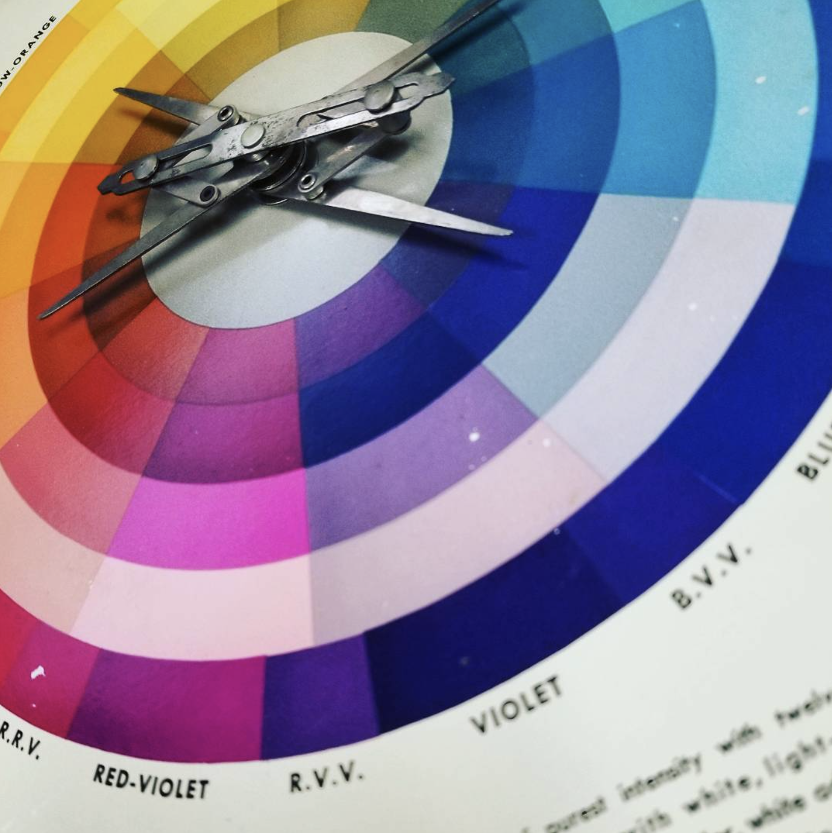 Color wheel with metal scissors on top