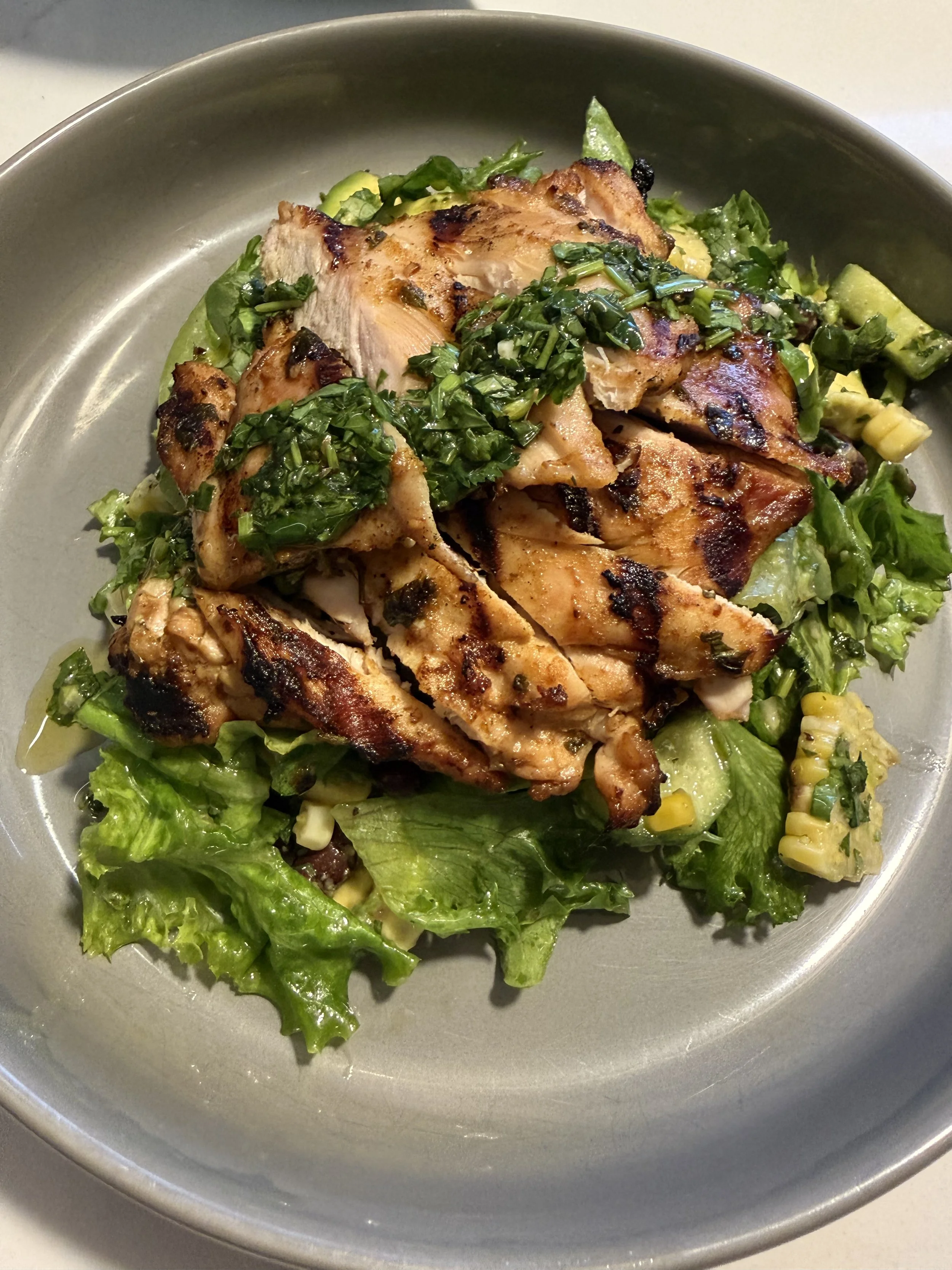 Pollo à la Brasa Chicken Thighs, Black Beans, Avocado, Grilled Corn, Cucumber, Greens, Chimichurri