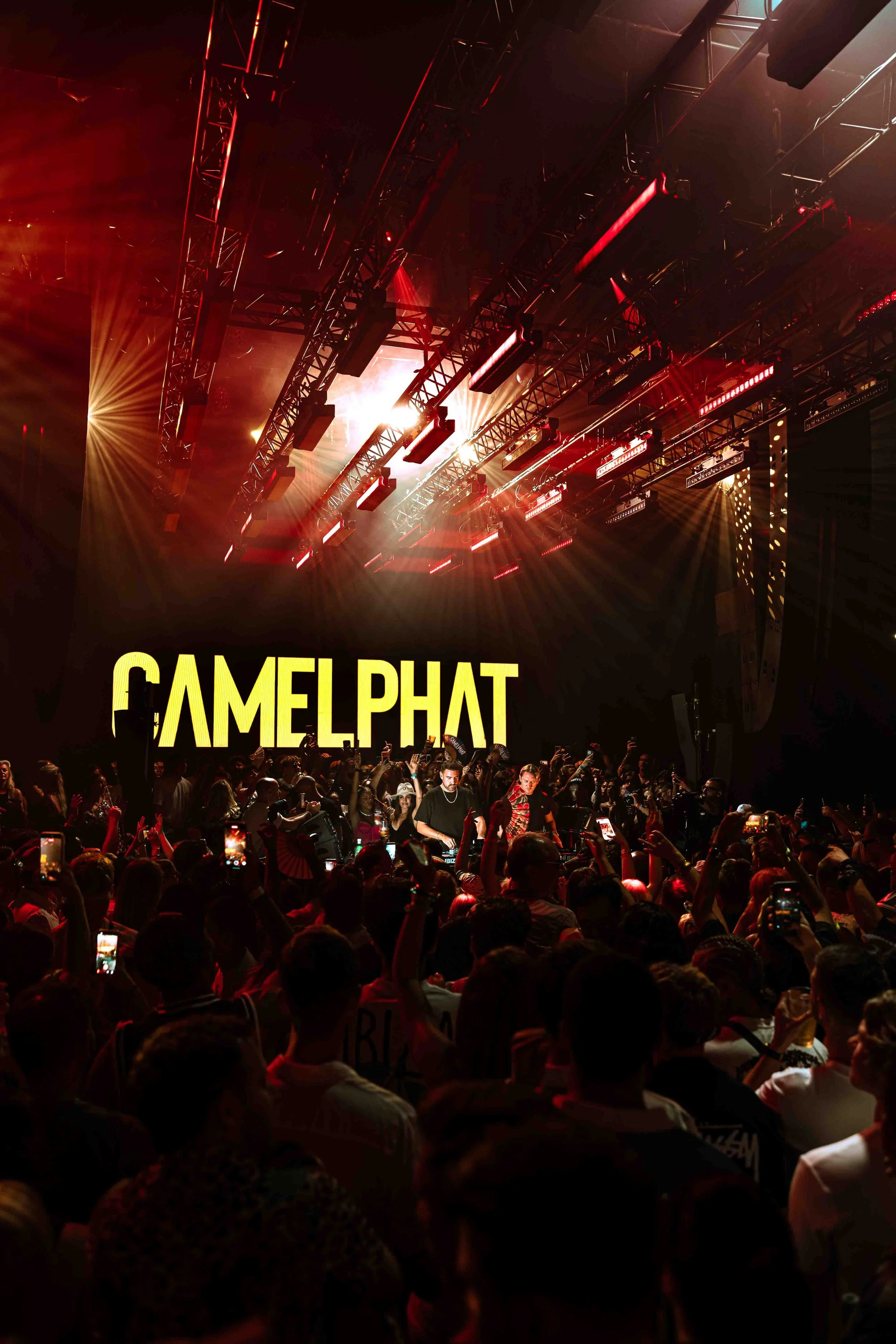 Concert scene with stage lighting and a crowd of people, with the word 'CAMELPHAT' displayed on a screen.