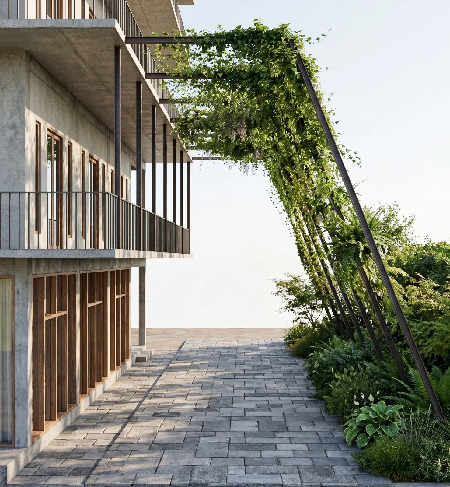 A modern building with a balcony, wooden slat walls, and large windows. There is a patio with a paved walkway and greenery, including climbing plants on metal supports, on the right side of the image. The sky is clear and the scene is well-lit by sun