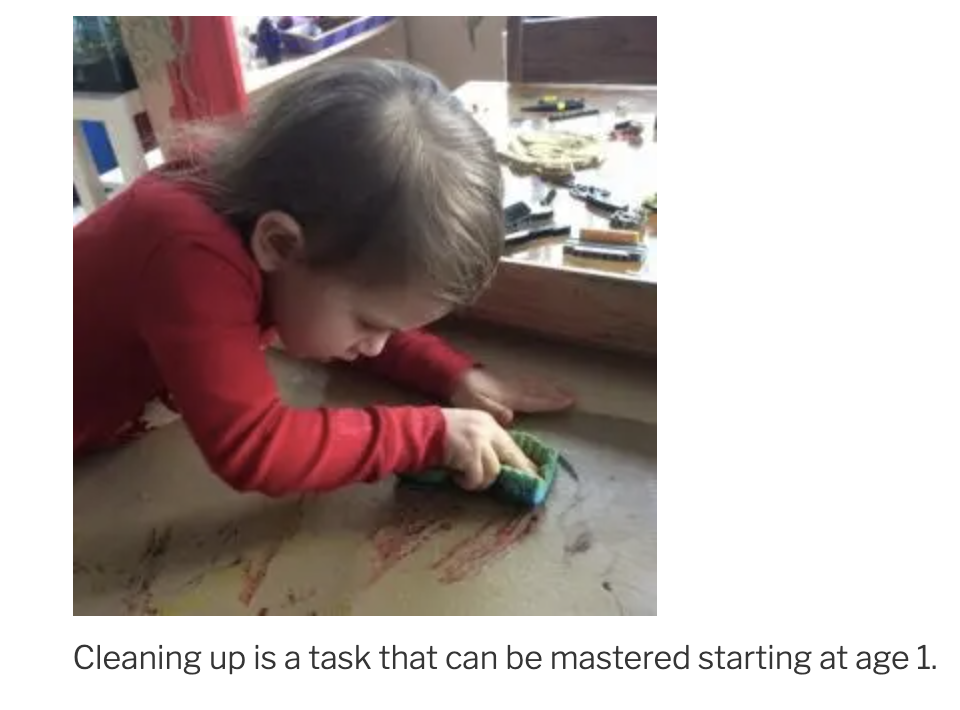 One year old scrubbing a table after working at it