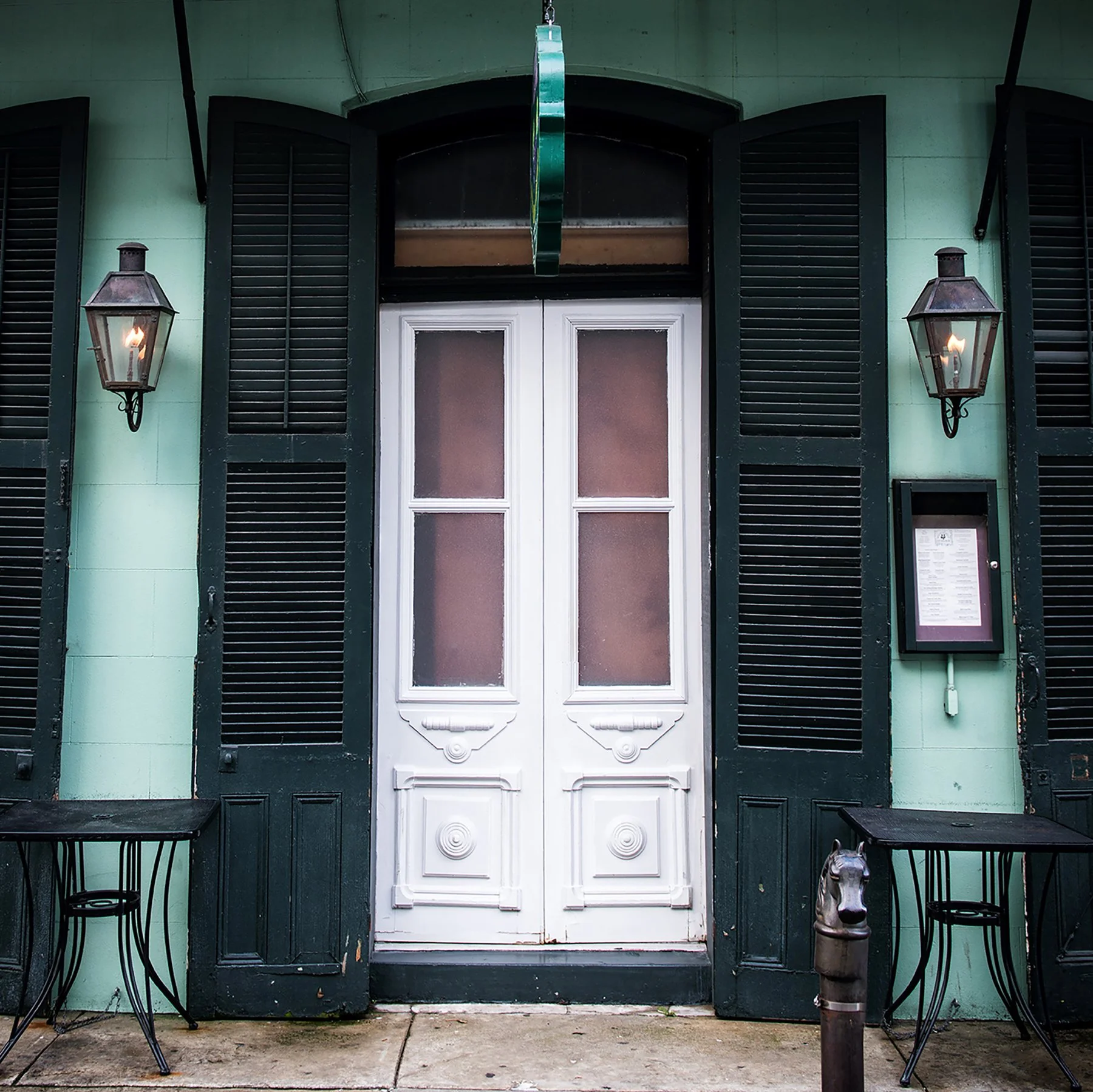 Sometimes it’s the little things that capture the spirit of a place. While wandering the streets of the French Quarter, this charming restaurant facade caught my eye — complete with classic gas lanterns, tall green shutters, and double white panel do