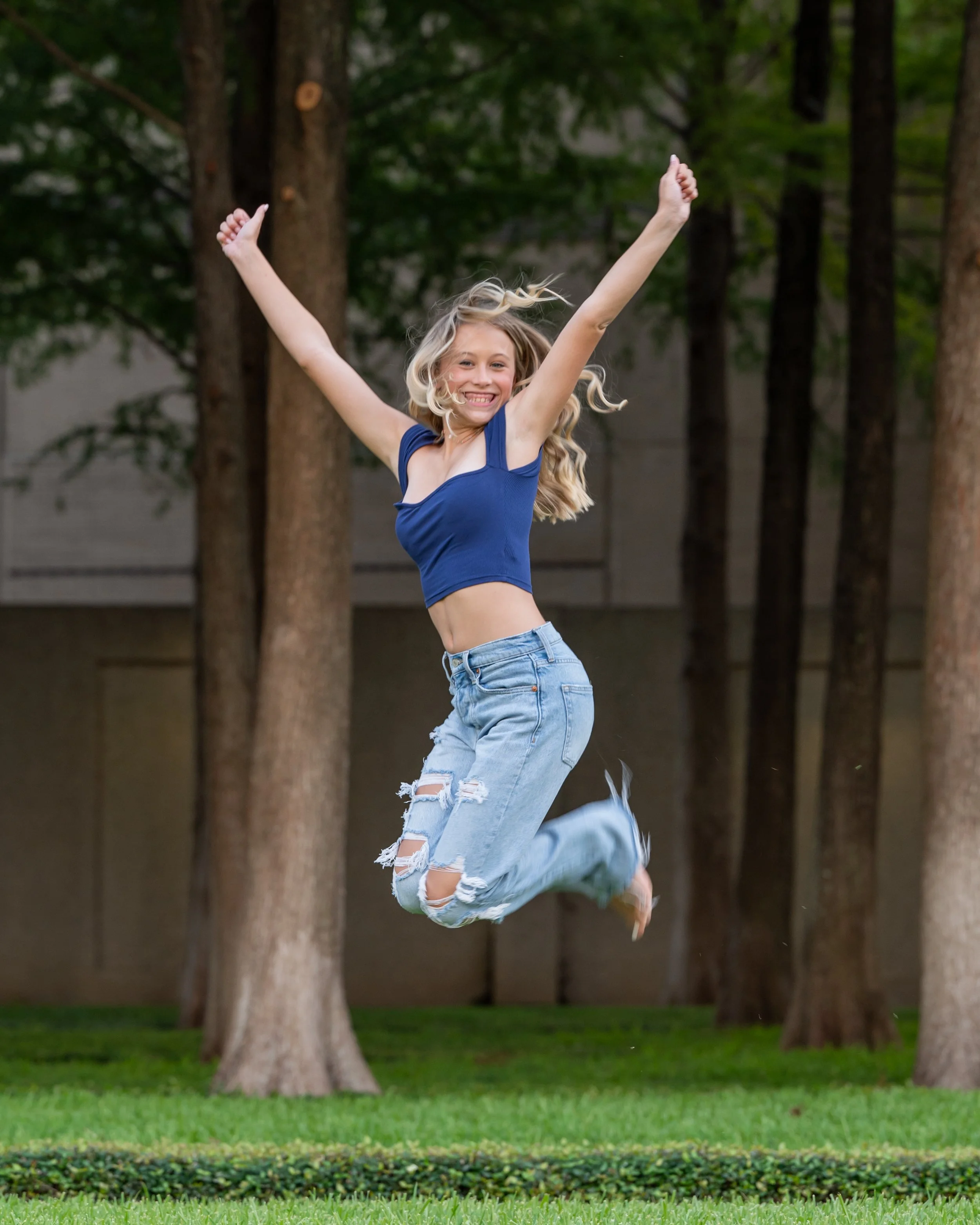 girl-jumping-jeans-blue-top.jpg