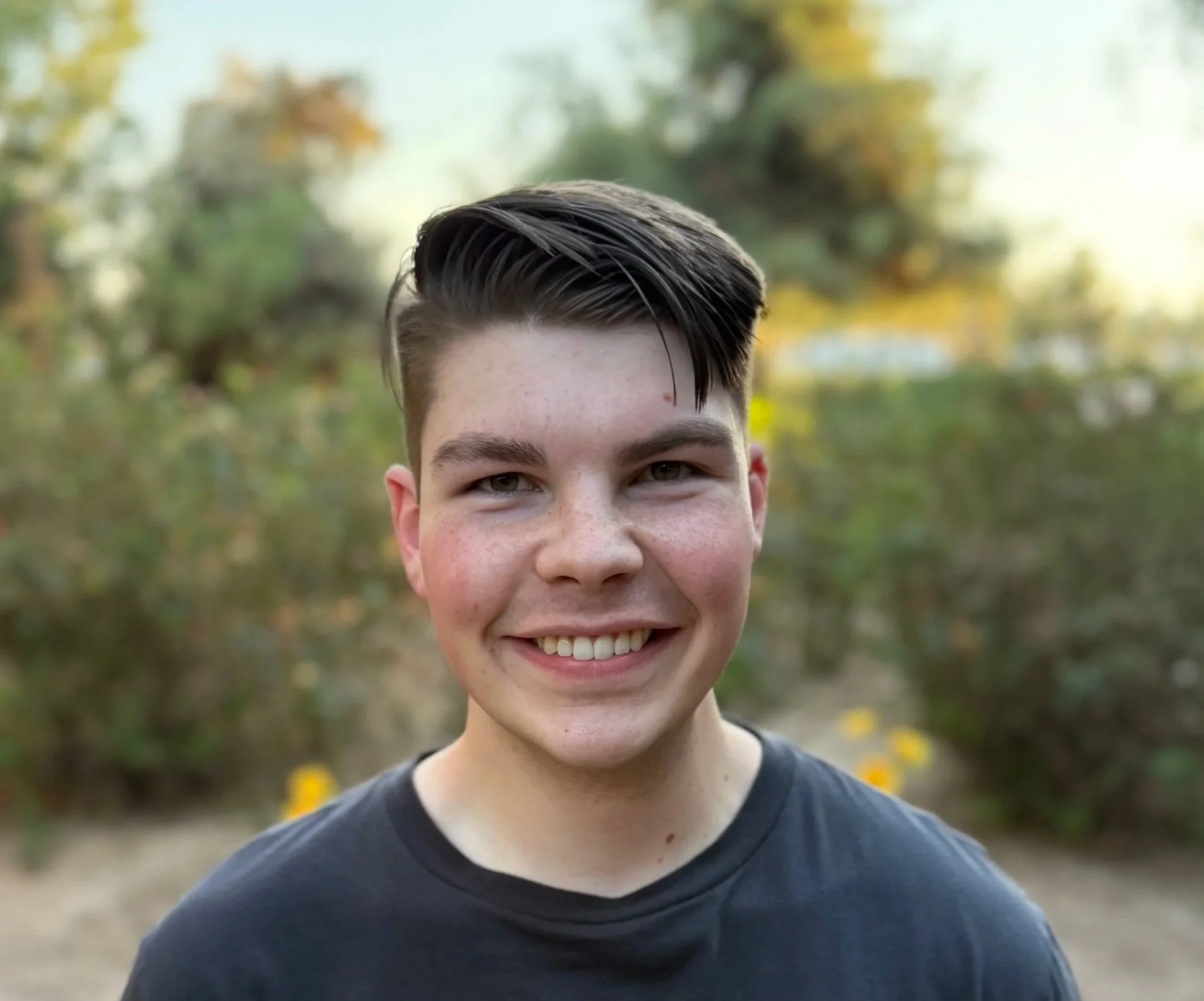 portrait of a man standing in front of trees
