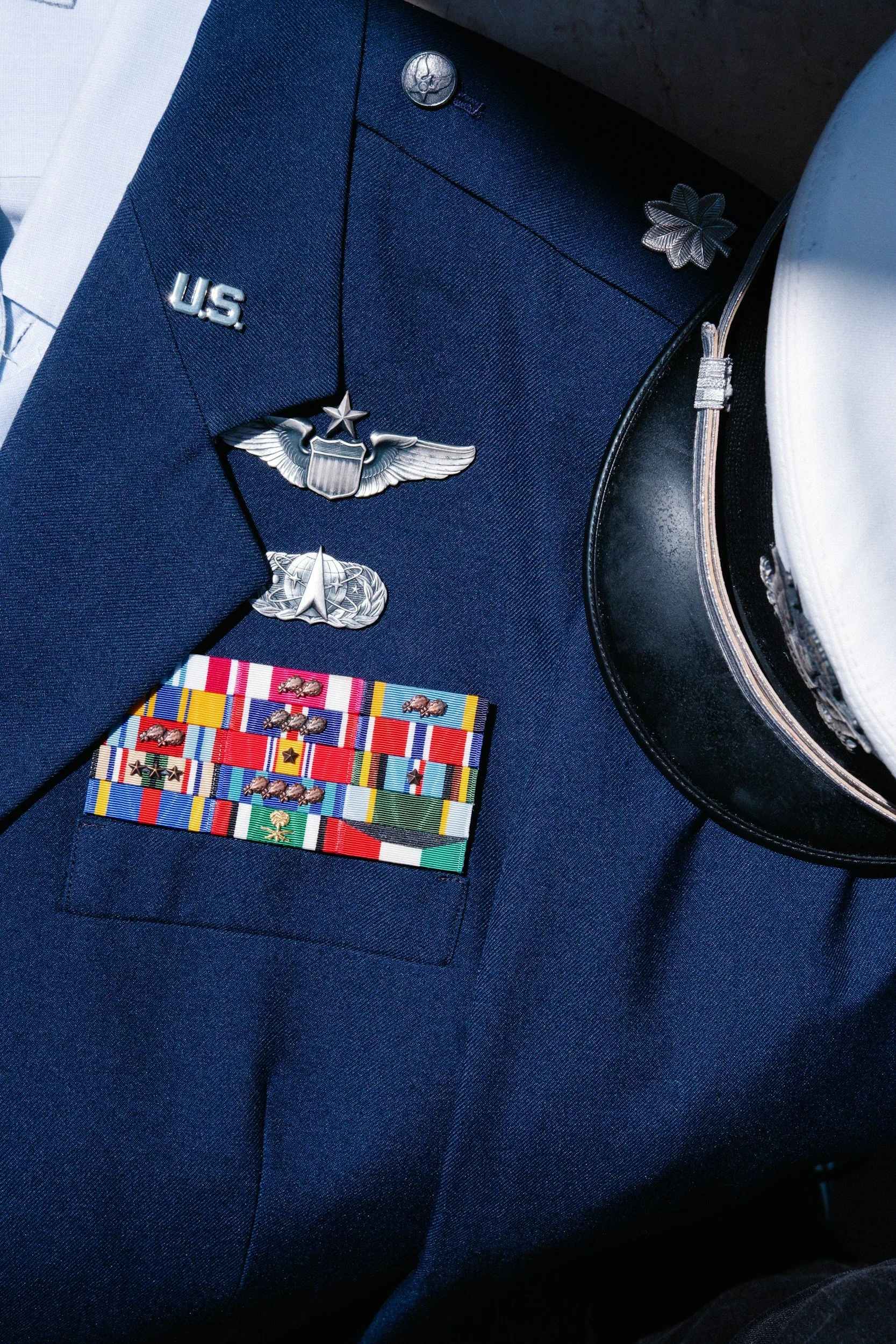 Close-up of a United States Air Force officer's uniform with various medals, patches, and insignia.