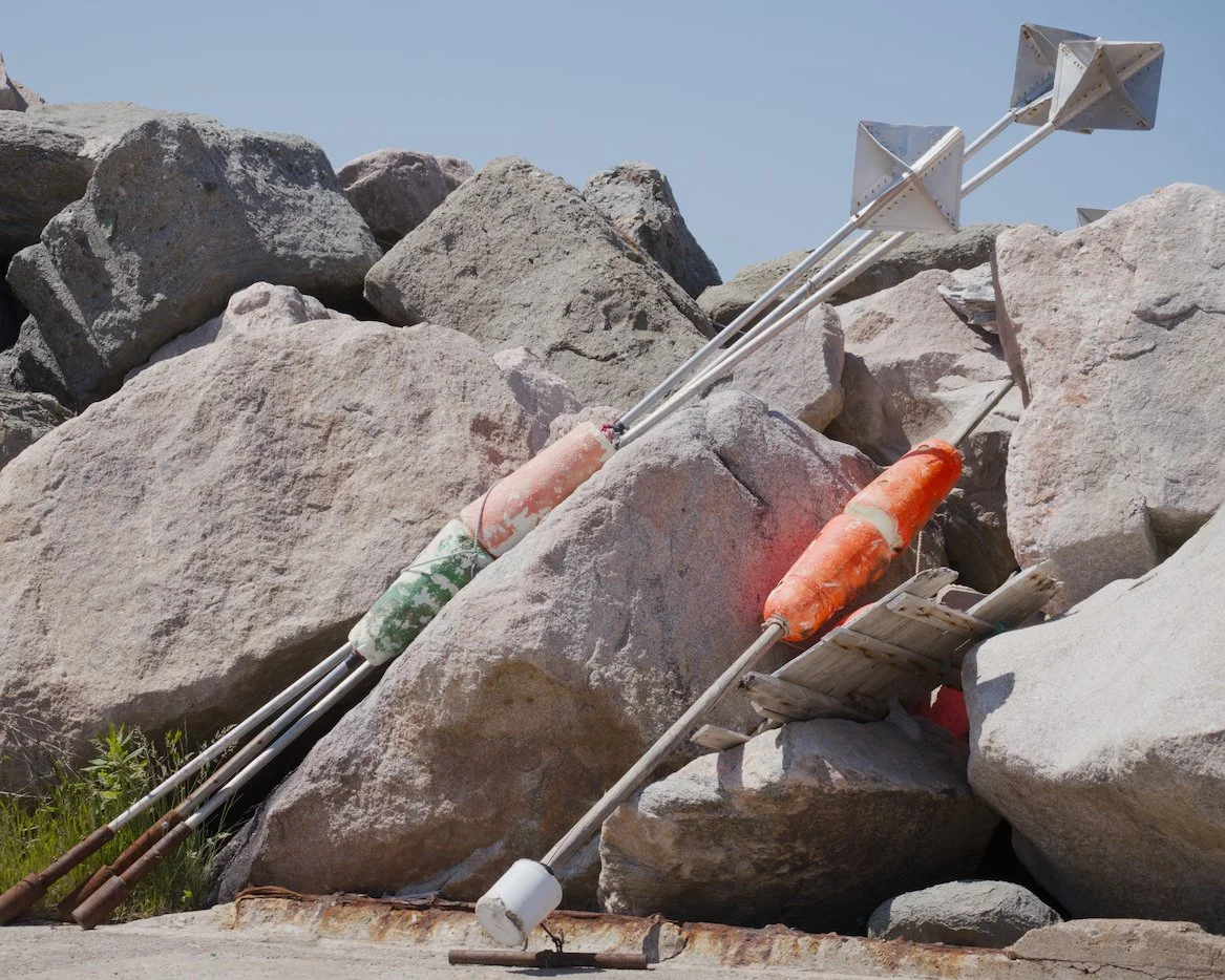 Bouys leaning against jetty