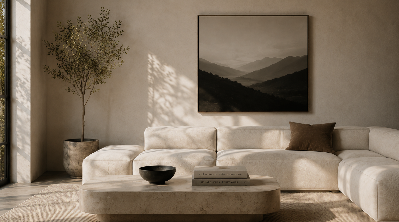 A minimalist living room with a white sectional sofa, a marble coffee table, a black bowl, a book, a brown pillow, a tall potted plant, and a mountain landscape painting on the wall. Sunlight casts shadows through large windows.