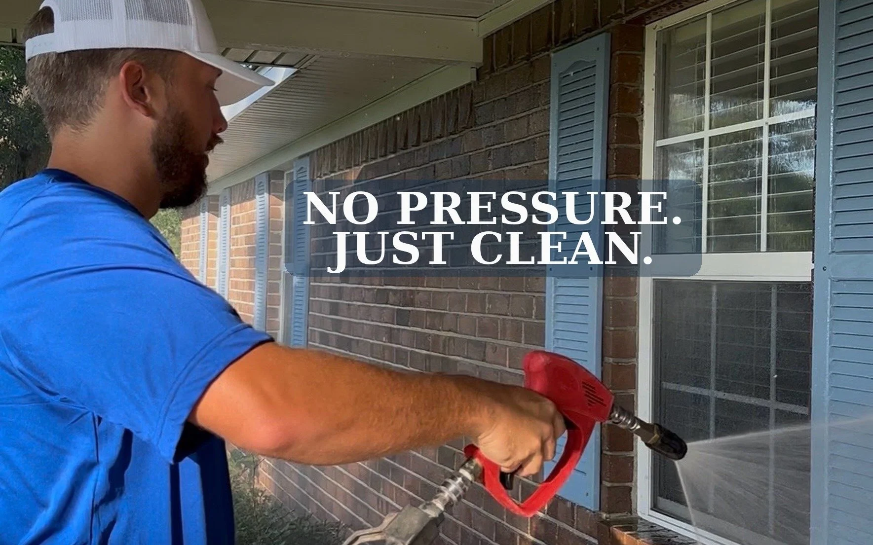 Bryce Stephens of Stephens Exteriors soft washing a brick home with a low-pressure soft wash gun in Statesboro, GA — 'No Pressure. Just Clean.'