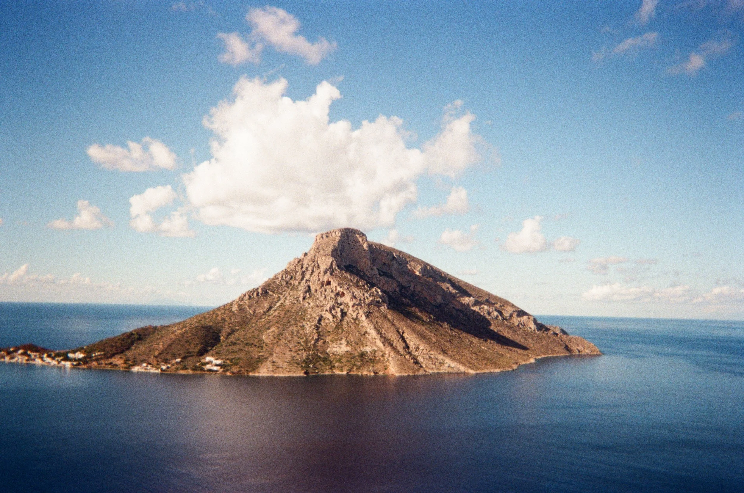 Greek Island Talendos, stands alone in the sea. taken from the grande Grotta Cave. 