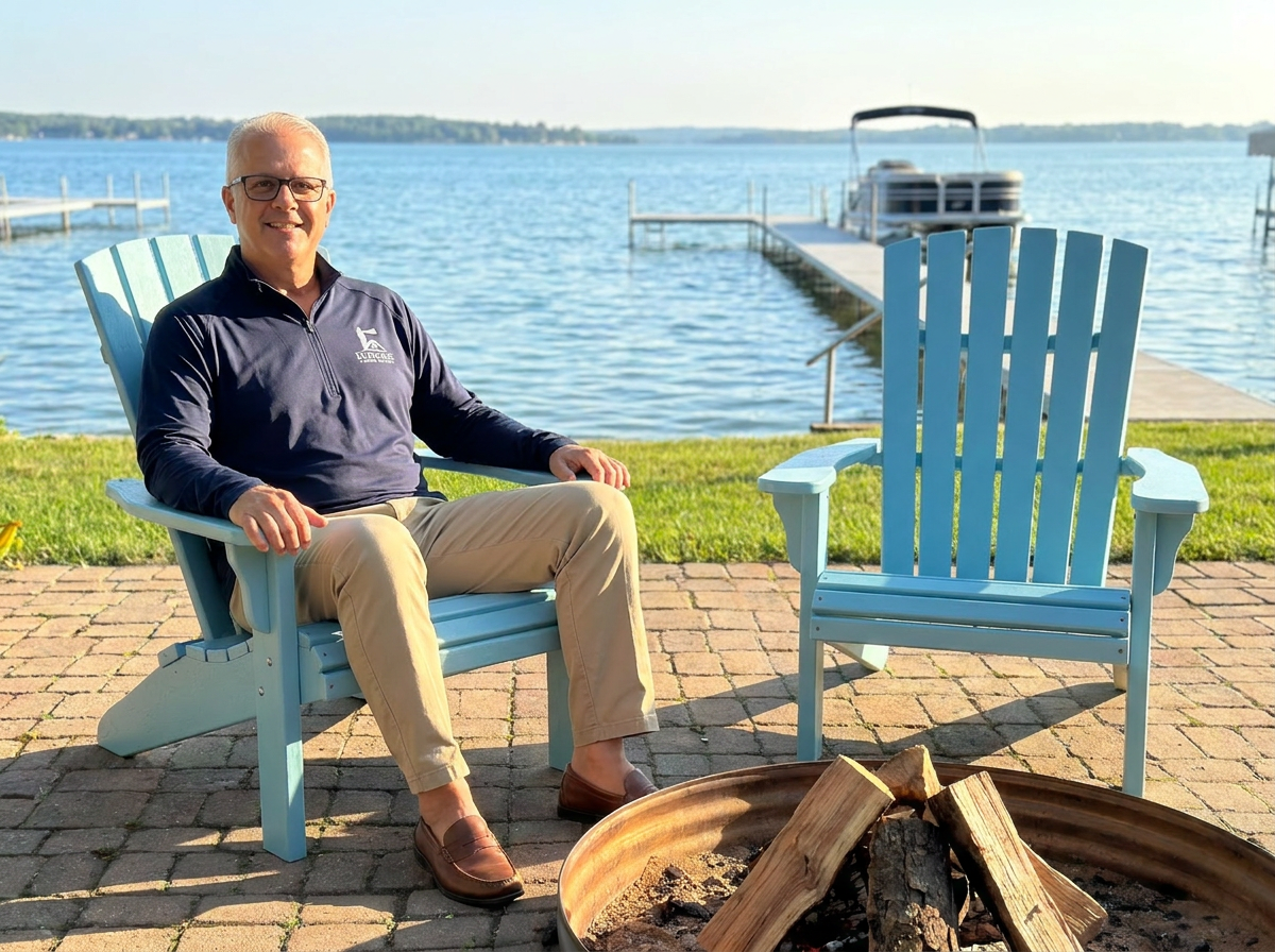 Jim Casler of Daymark Home Watch testing out the firepit and the comfy Adirondack chairs at client home in Bear Lake, Michigan.