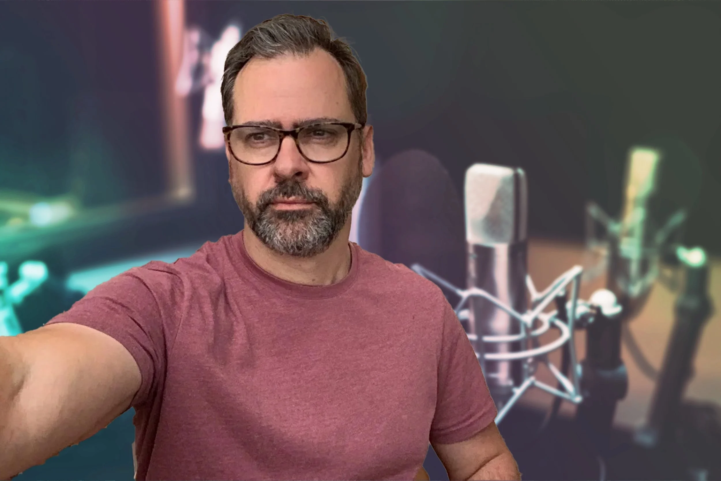 Ewan Innes of Positive Life Therapy taking a selfie in a recording studio with a large microphone and computer equipment in the background.