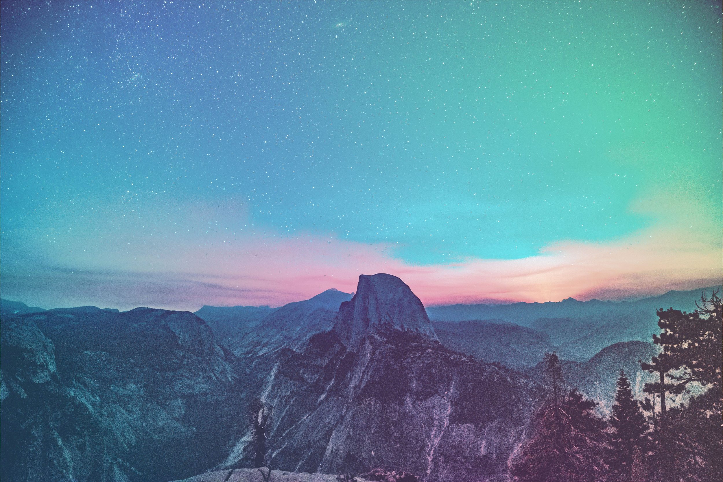A gradient-colourized landscape with mountains, trees, and a rock formation under a colorful night sky filled with stars.