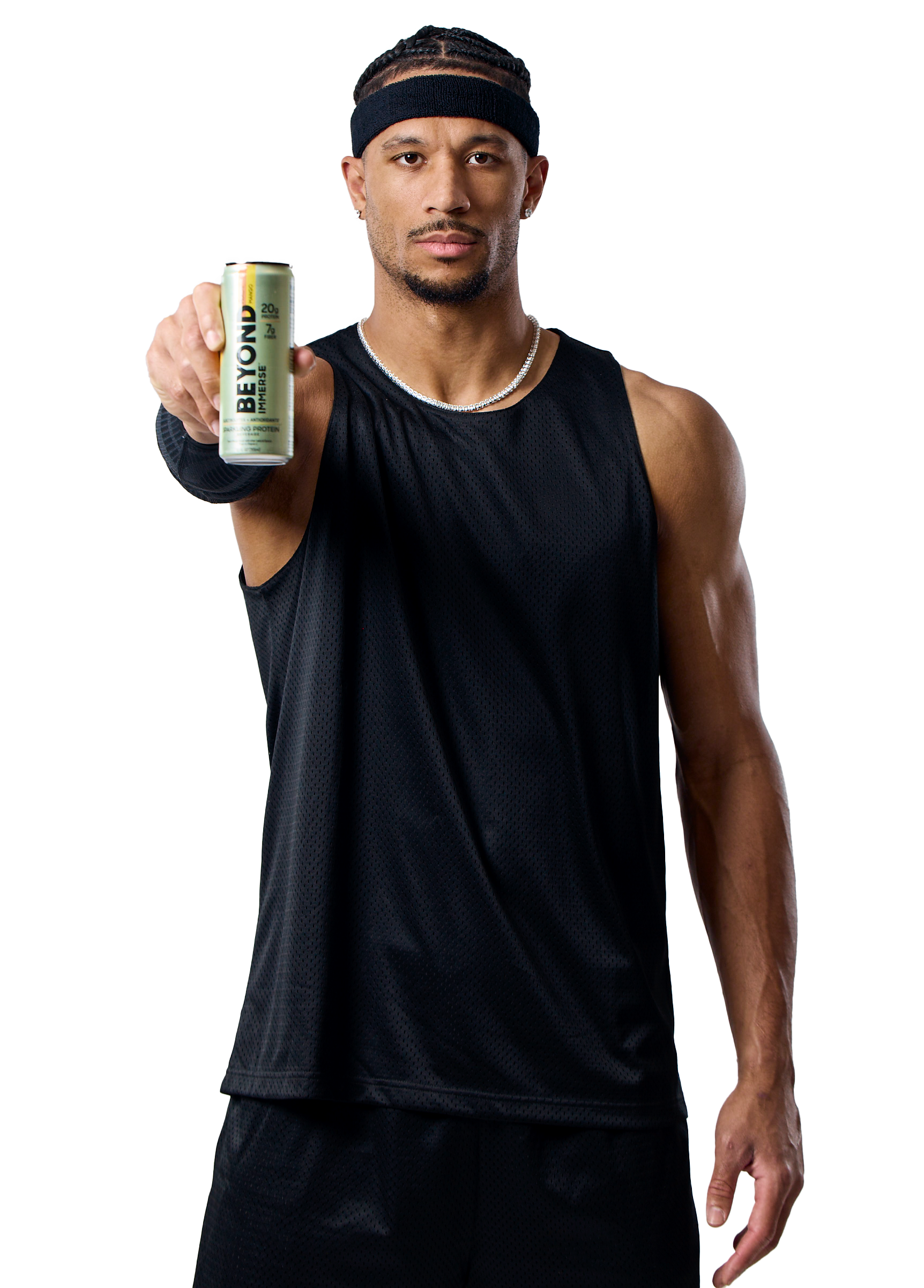 A young man with braided hair wearing a black sports headband, sleeveless black athletic shirt, and a silver chain necklace, holding up a can of Beyond energy drink towards the camera.