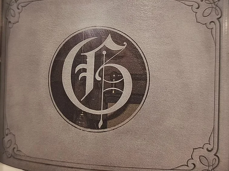 A circular logo with an ornate G for "Grantwood Steak & Seafood."