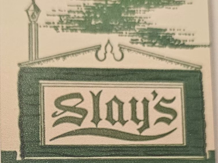Green colored sign saying "Slay's Restaurant and Cocktail Lounge."