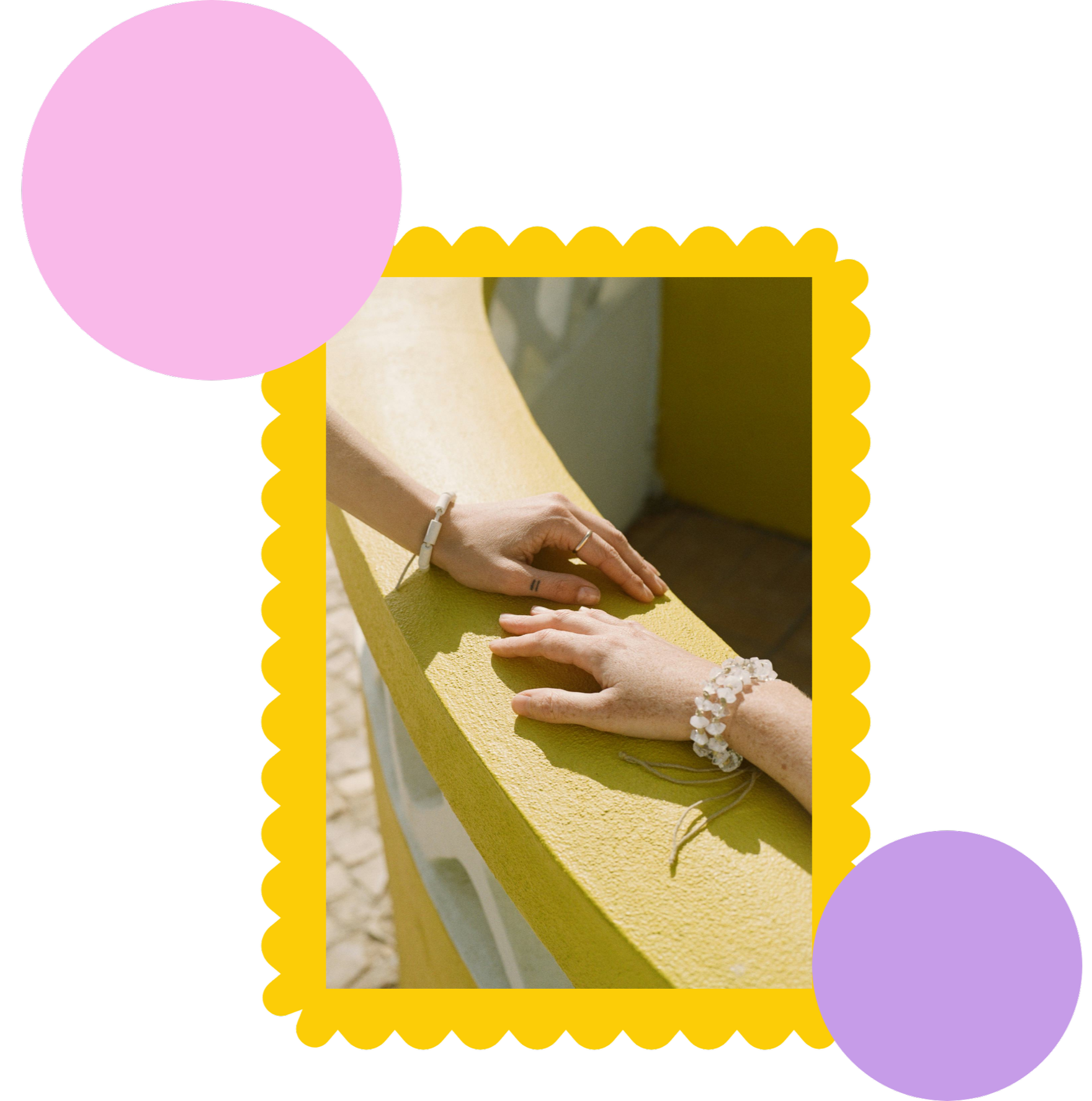 Two people holding hands on a yellow bench, with one person wearing a white bracelet and the other wearing a ring.