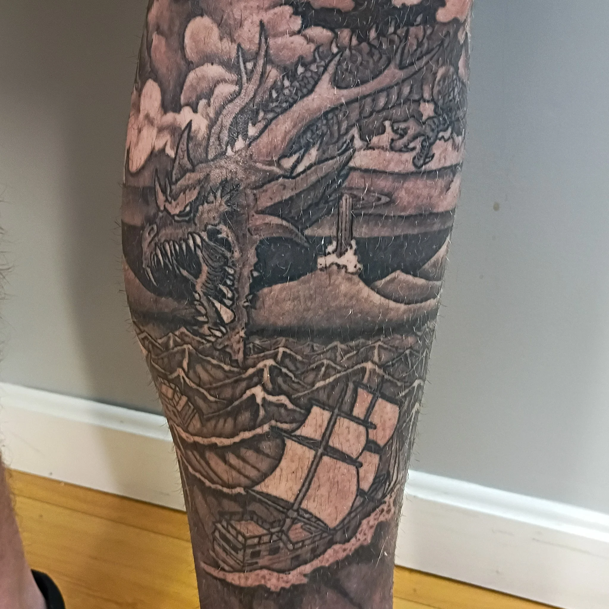 black and grey leg sleeve with dragon and castles 