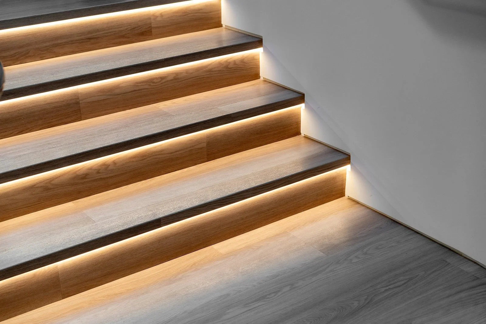 Modern wood staircase with integrated lighting representing taking the next step with Interior Law LLP.