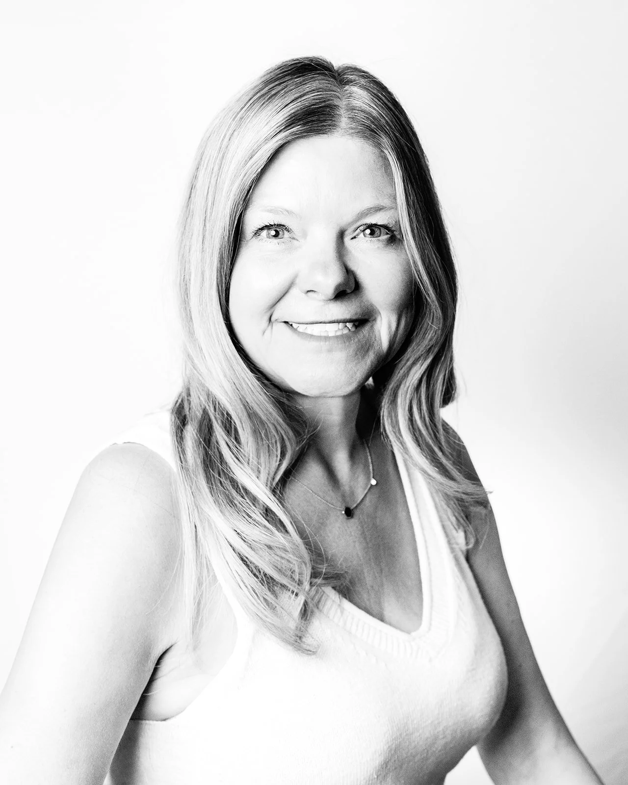 A black and white portrait of Kim Kelly