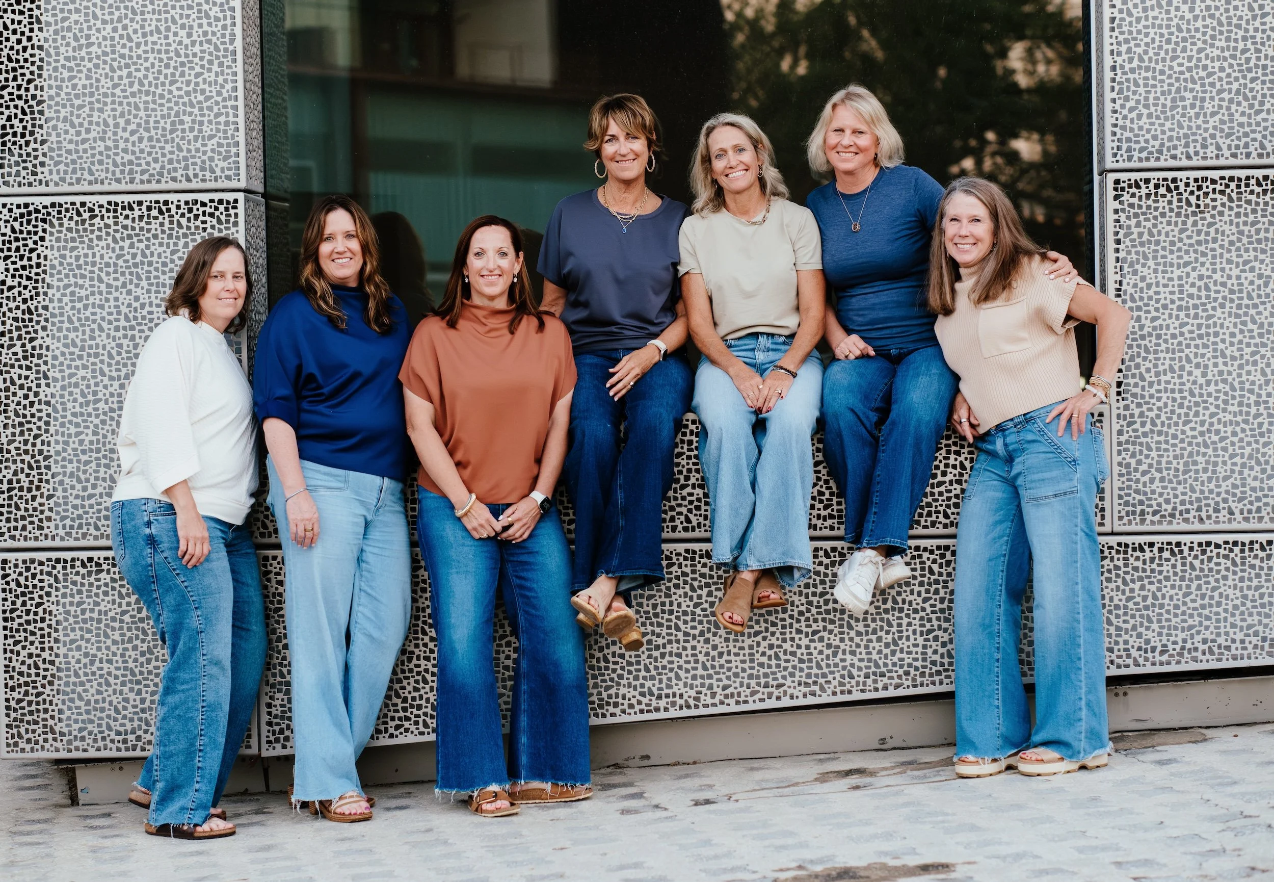 seven founding members of the water bearer collective standing outdoors