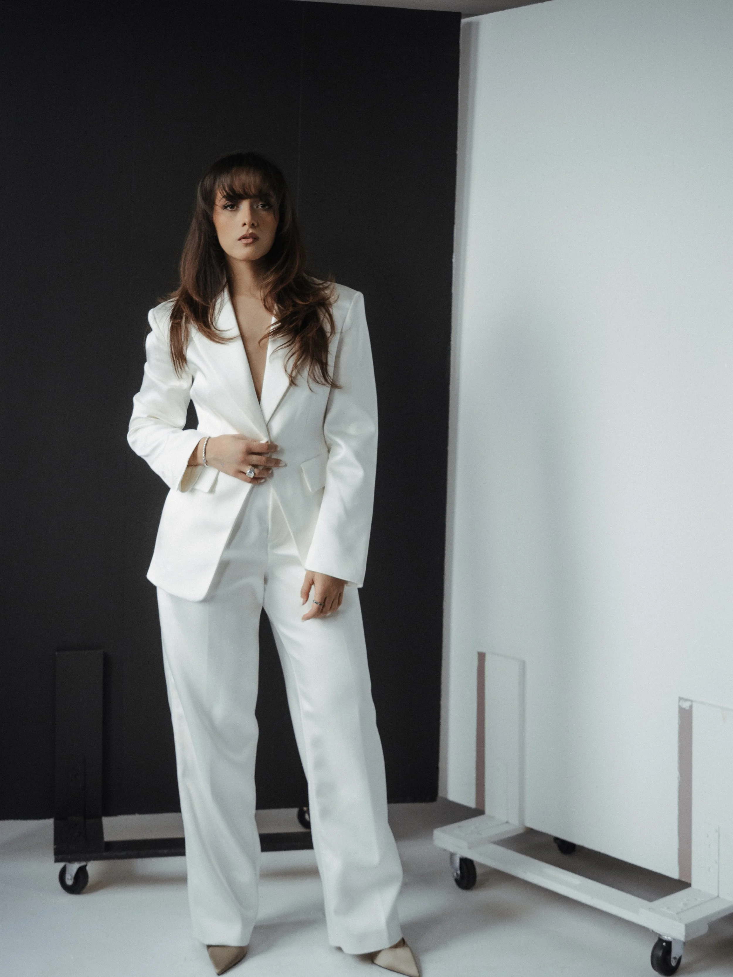 Editorial portrait of ATANTIK’s image consultant in a studio wearing a white suit.