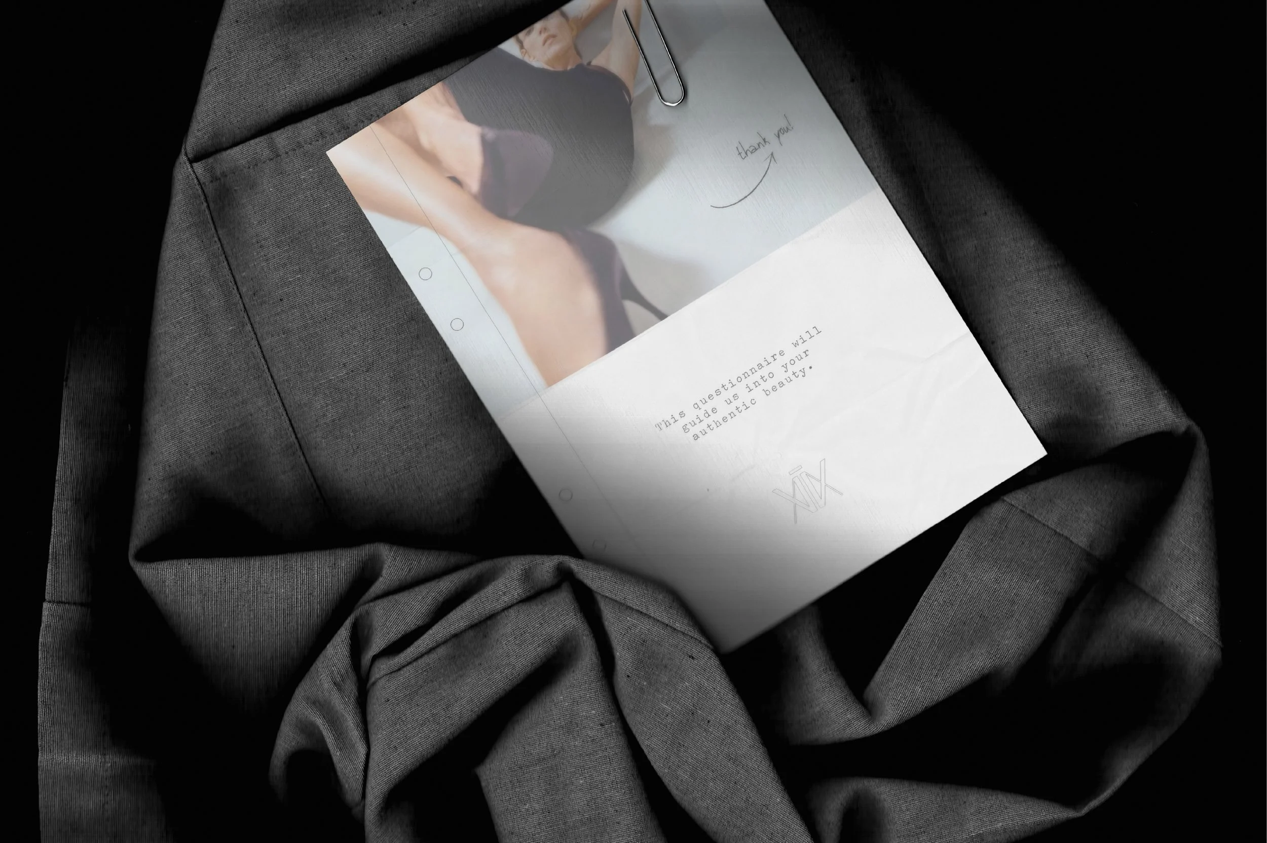 Fashion brand stationery resting on a gray blazer. Image consultant, color analysis, fashion, editorial, moodboard, fashion moodboard, atantik, image analysis, color analysis, identity questionnaire, image questionnaire, beauty, style, fashion brand