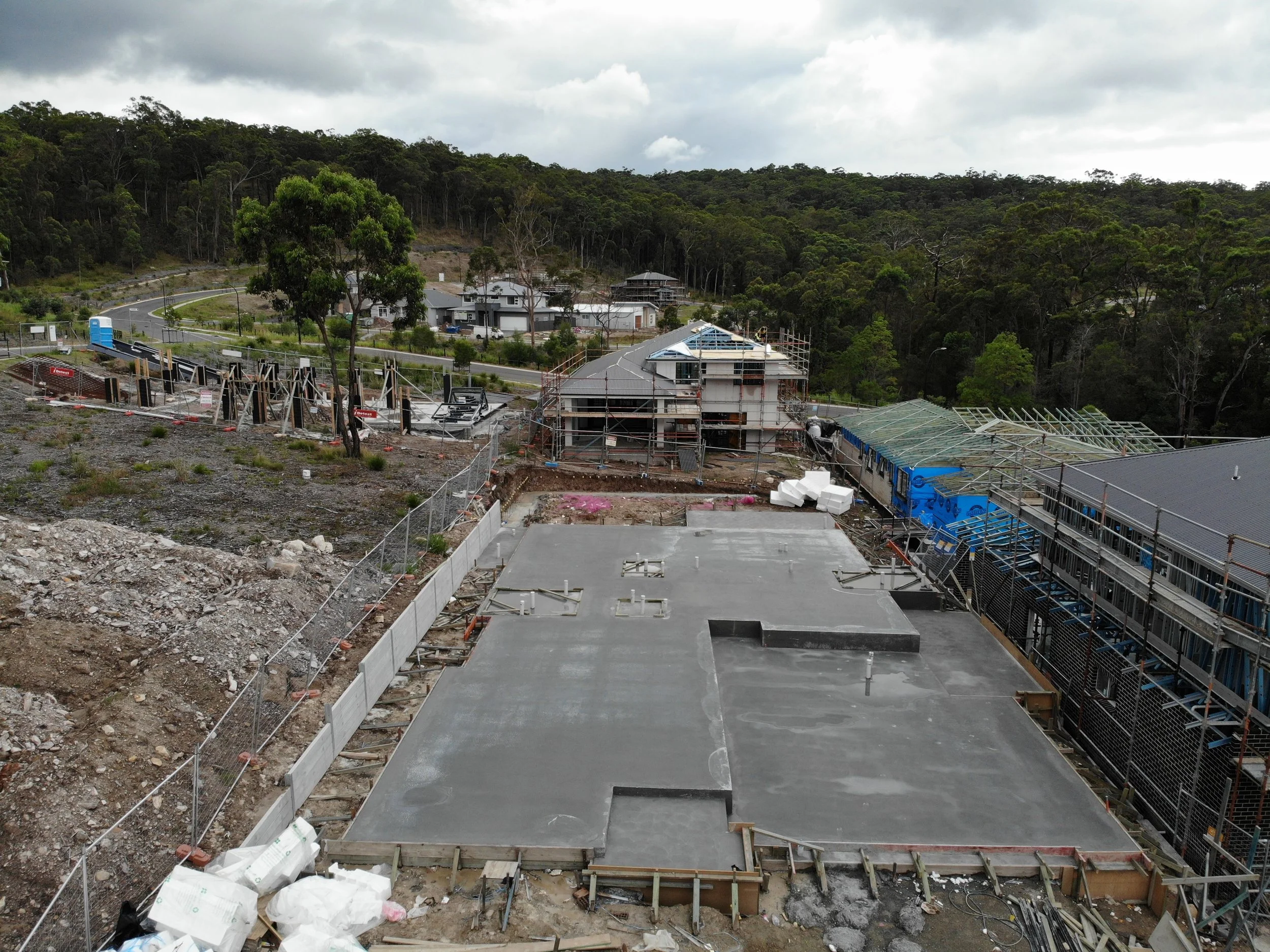 Construction site with partially built houses and scaffolding