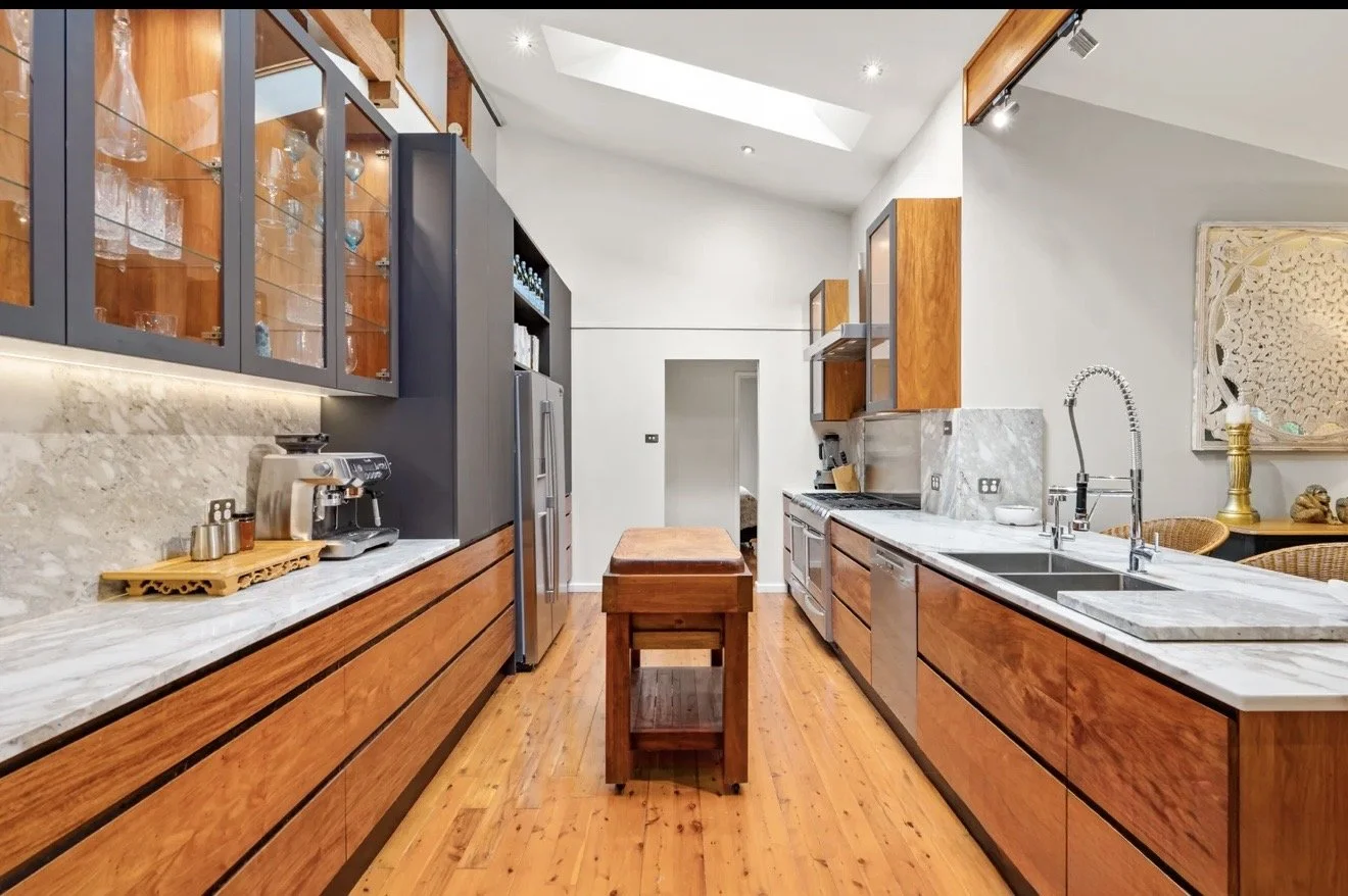 Modern kitchen with wooden cabinets and marble countertops