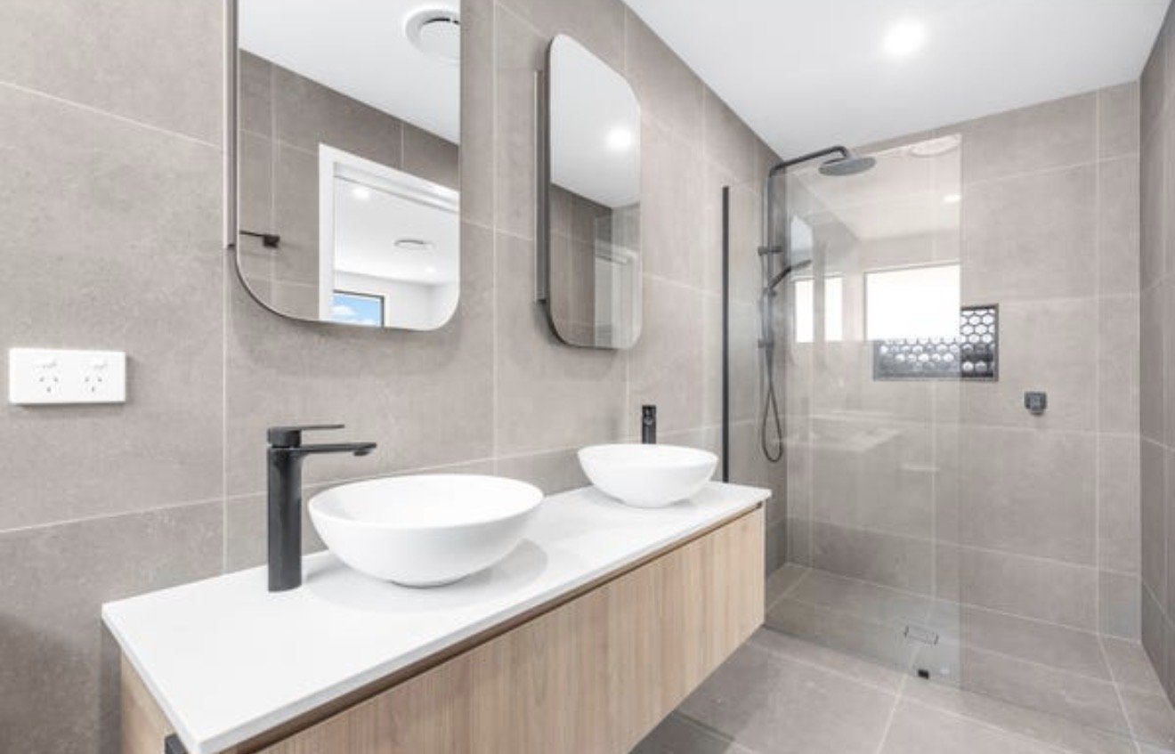 Modern bathroom with beige tiled walls and floor
