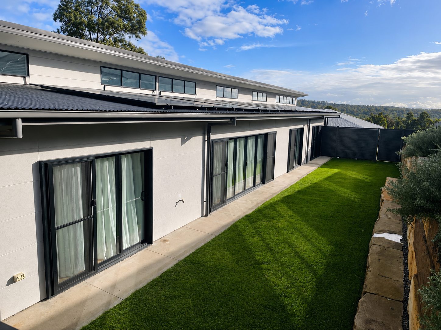 A modern house with a gray exterior in Newcastle custom home built by SWW BUILDING GROUP