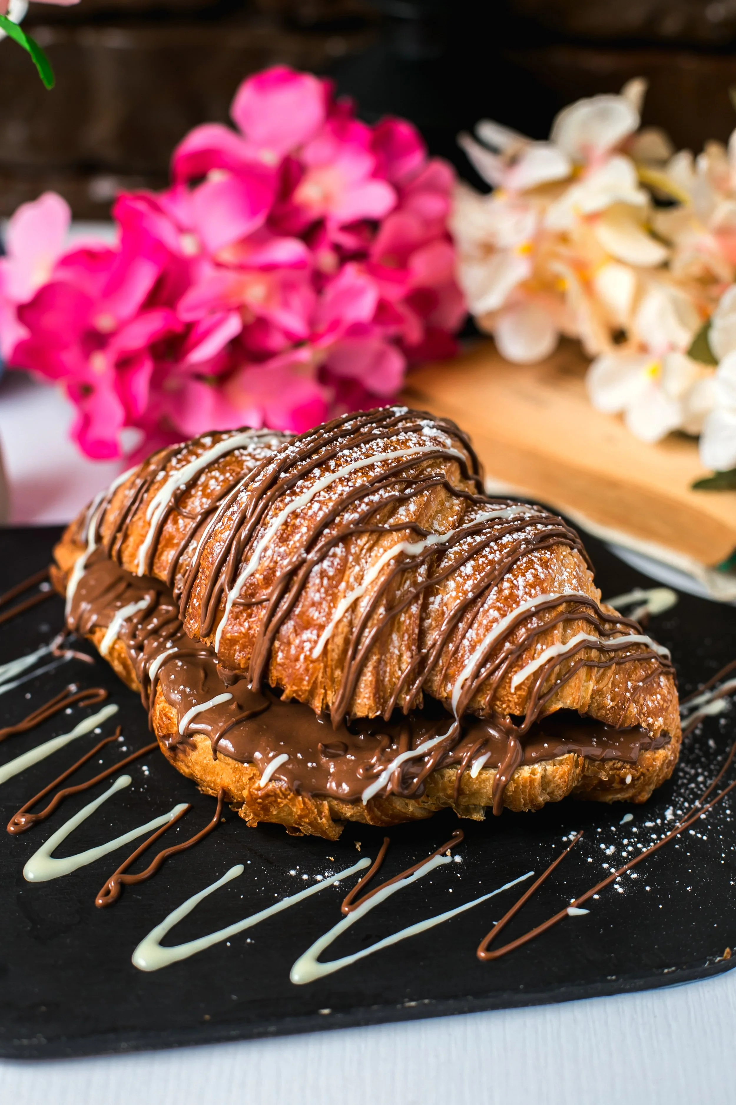 side-view-baked-croissant-with-chocolate-wooden-board.jpg