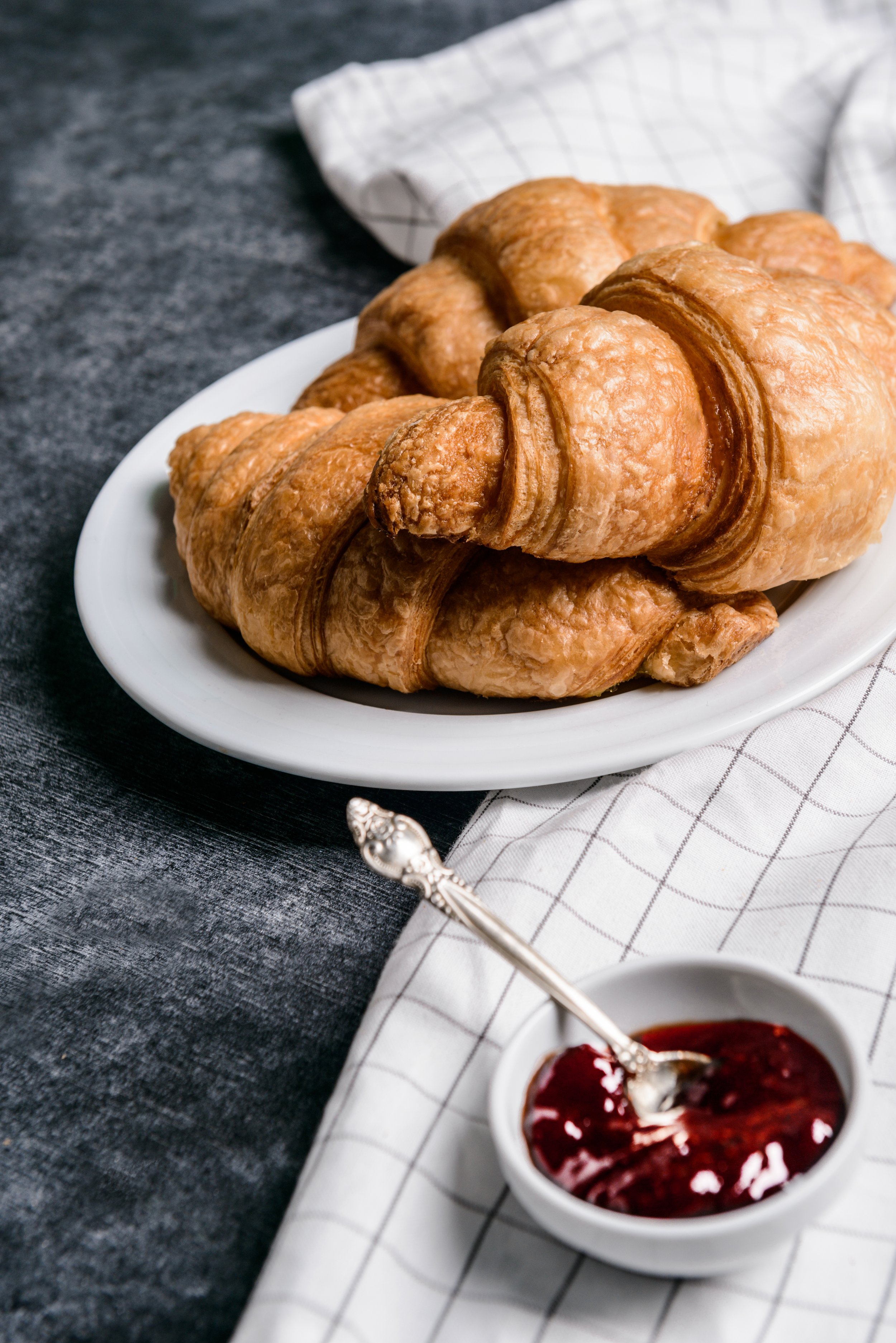 croissants-white-round-plate-pot-with-jam-aside.jpg