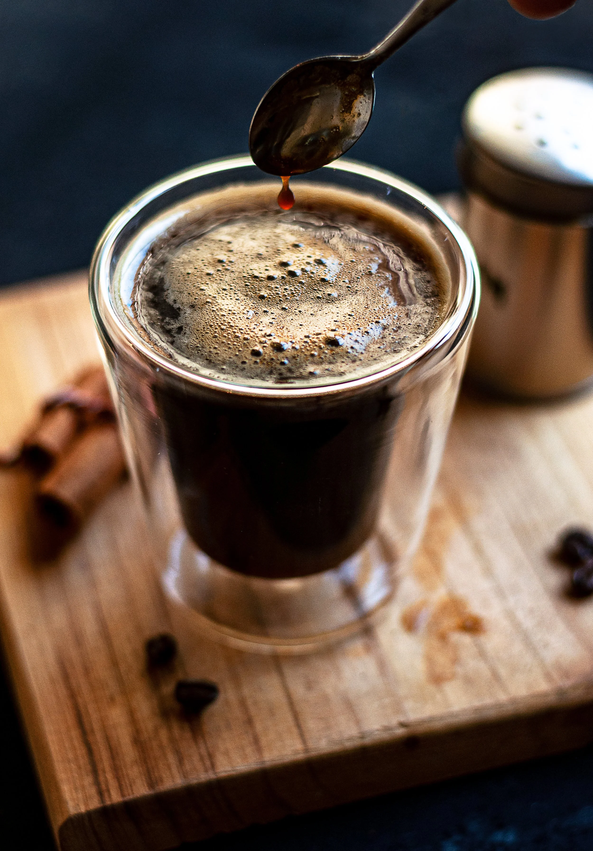 double-espresso-coffee-mug-with-cinnamon-sticks-coffee-beans-wooden-board.jpg