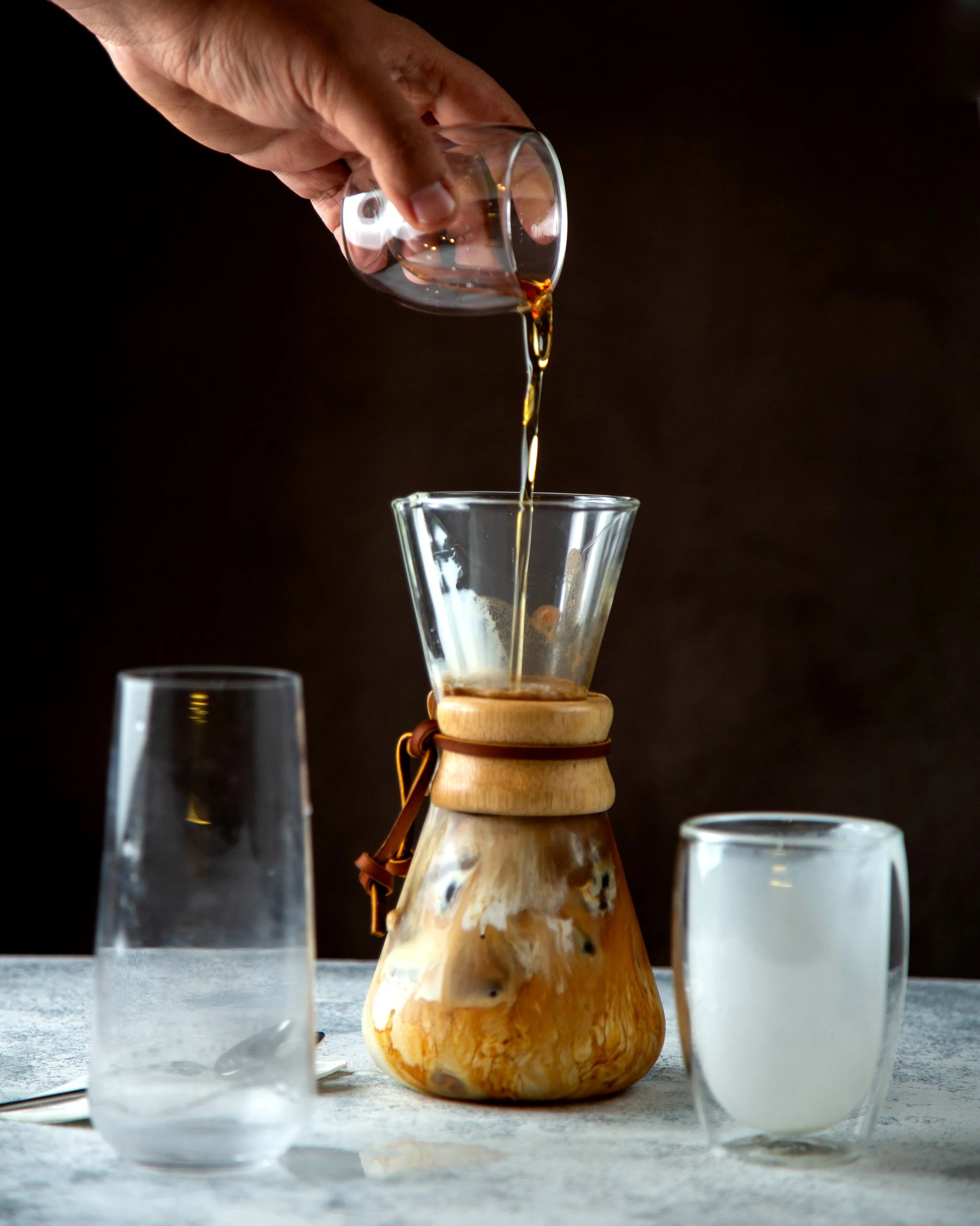 man-pouring-syrup-coffee-mixed-with-milk.jpg