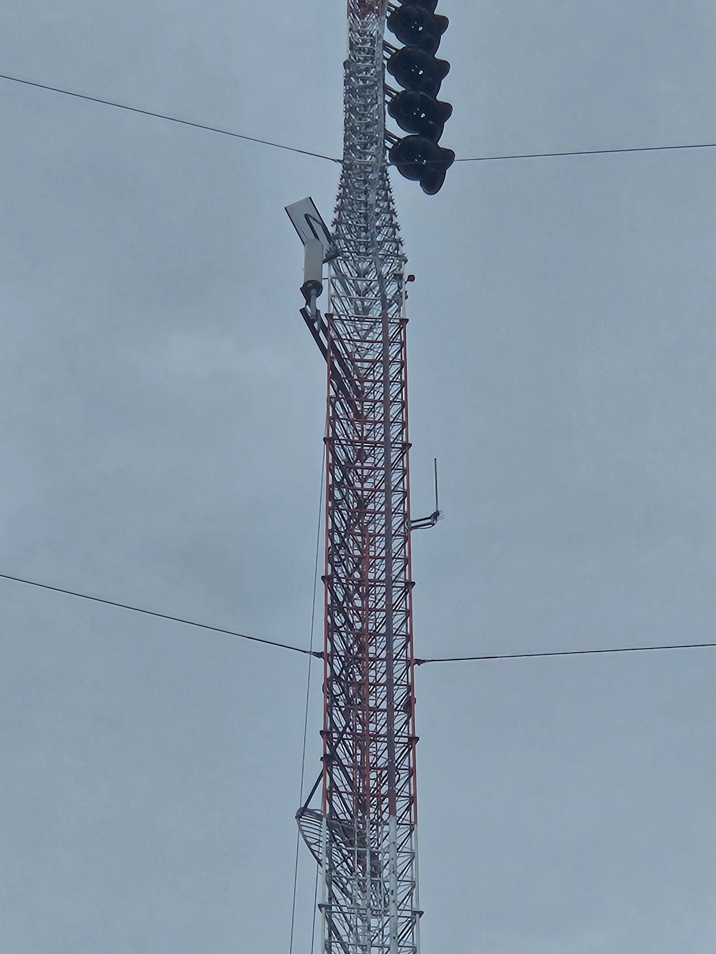 Communications tower with broadcast antennas and equipment installed by Green Country Tower Service. Expert tower rigging, antenna installation, equipment deployment, and communications infrastructure services nationwide.