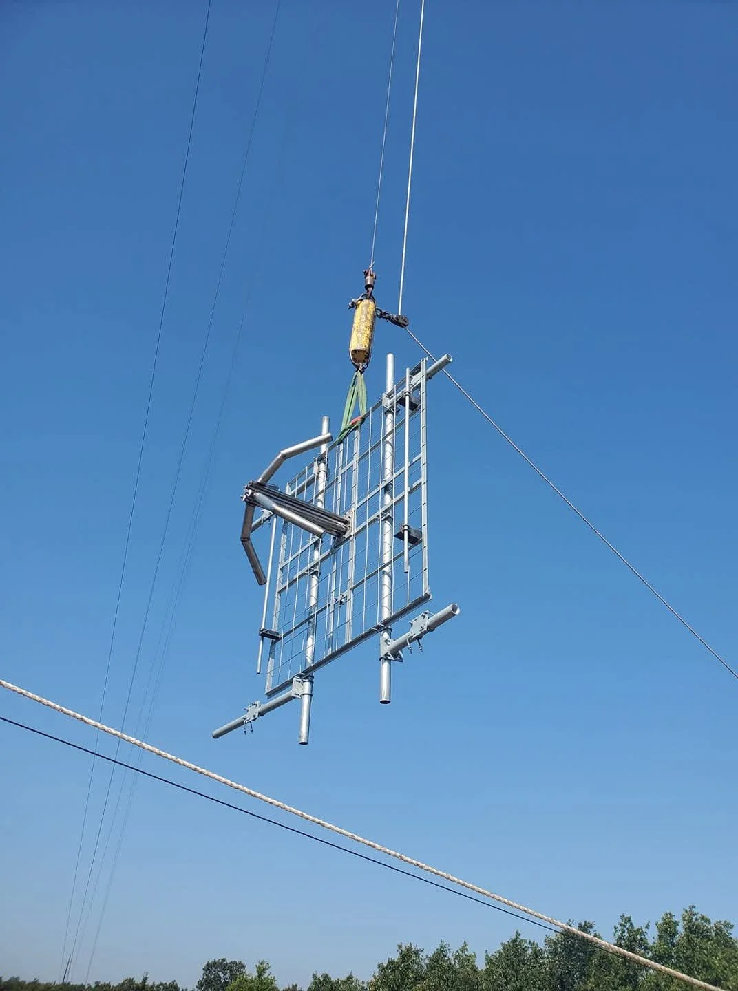 FM broadcast antenna installation using a hoist and trolley rigging system. Green Country Tower Service provides antenna installation, tower rigging, broadcast tower construction, and communications infrastructure services nationwide.