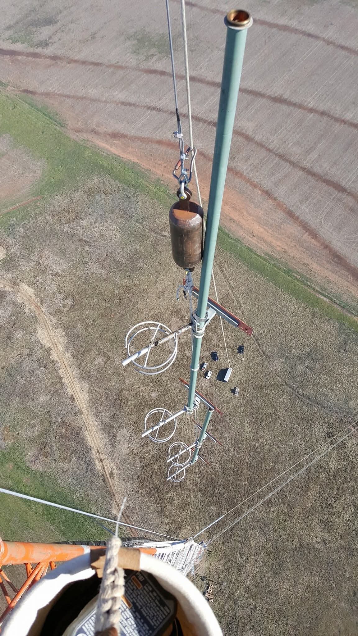 Hoisting FM broadcast antenna bays during a broadcast tower installation project. Green Country Tower Service provides antenna installation, tower rigging, equipment deployment, and communications infrastructure services nationwide.