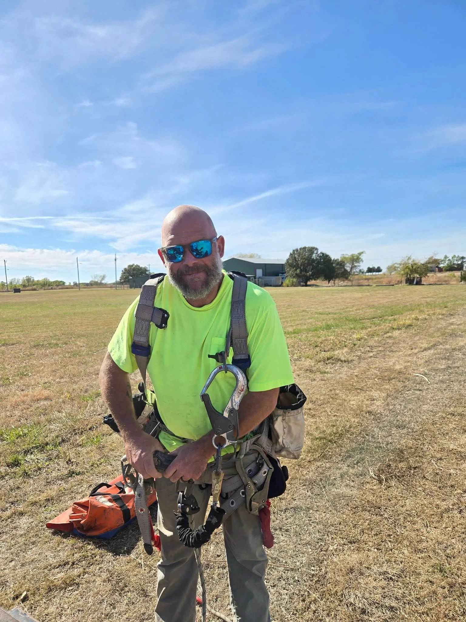 Green Country Tower Service LLC owner Cory Turner preparing for a high-elevation communications tower climb. Safety-focused tower maintenance, inspections, rigging, and communications infrastructure services performed nationwide.