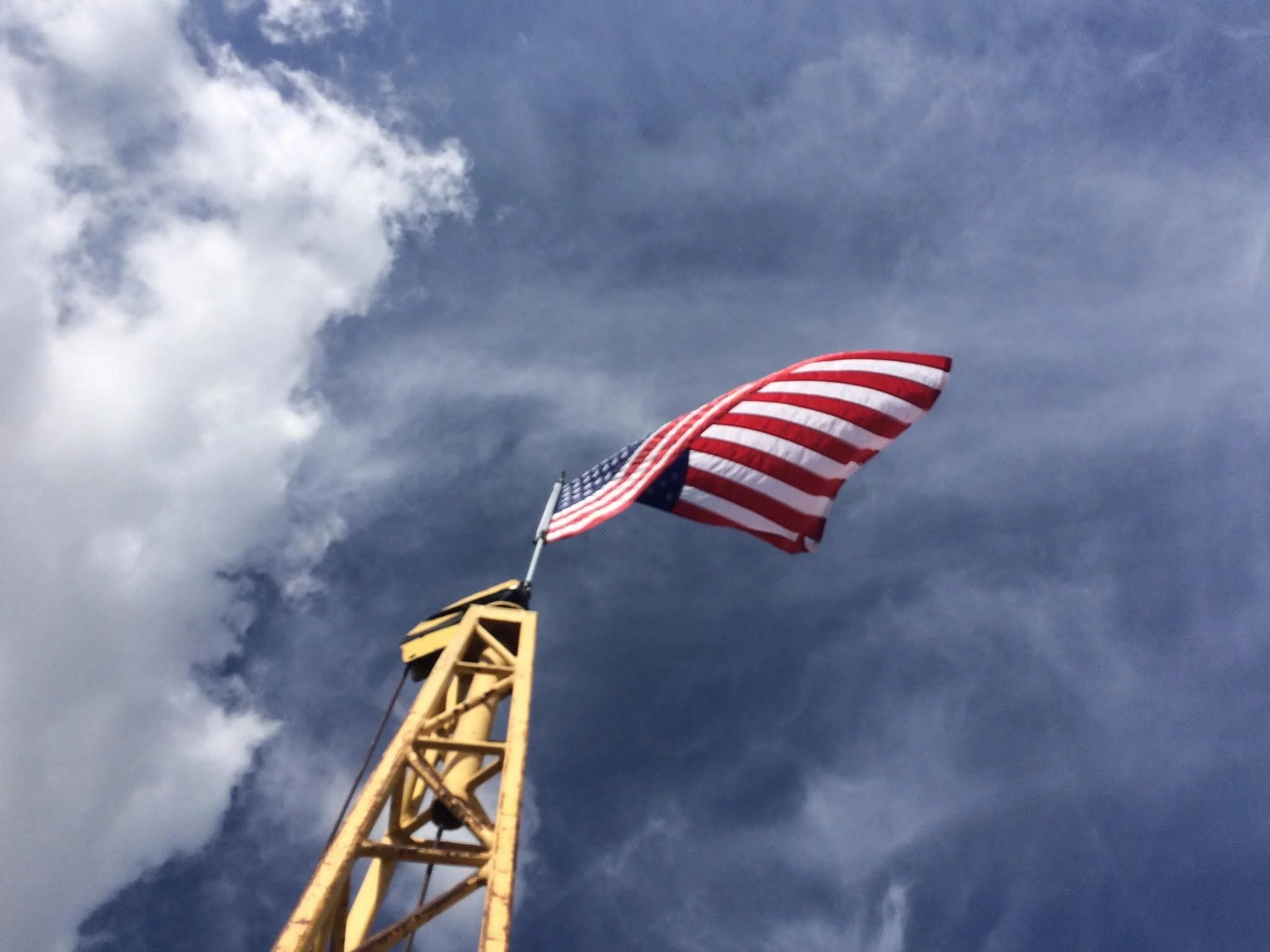Broadcast tower construction contractor stacking a communications tower. Certified tower climbers providing structural rigging and tower construction services nationwide.
