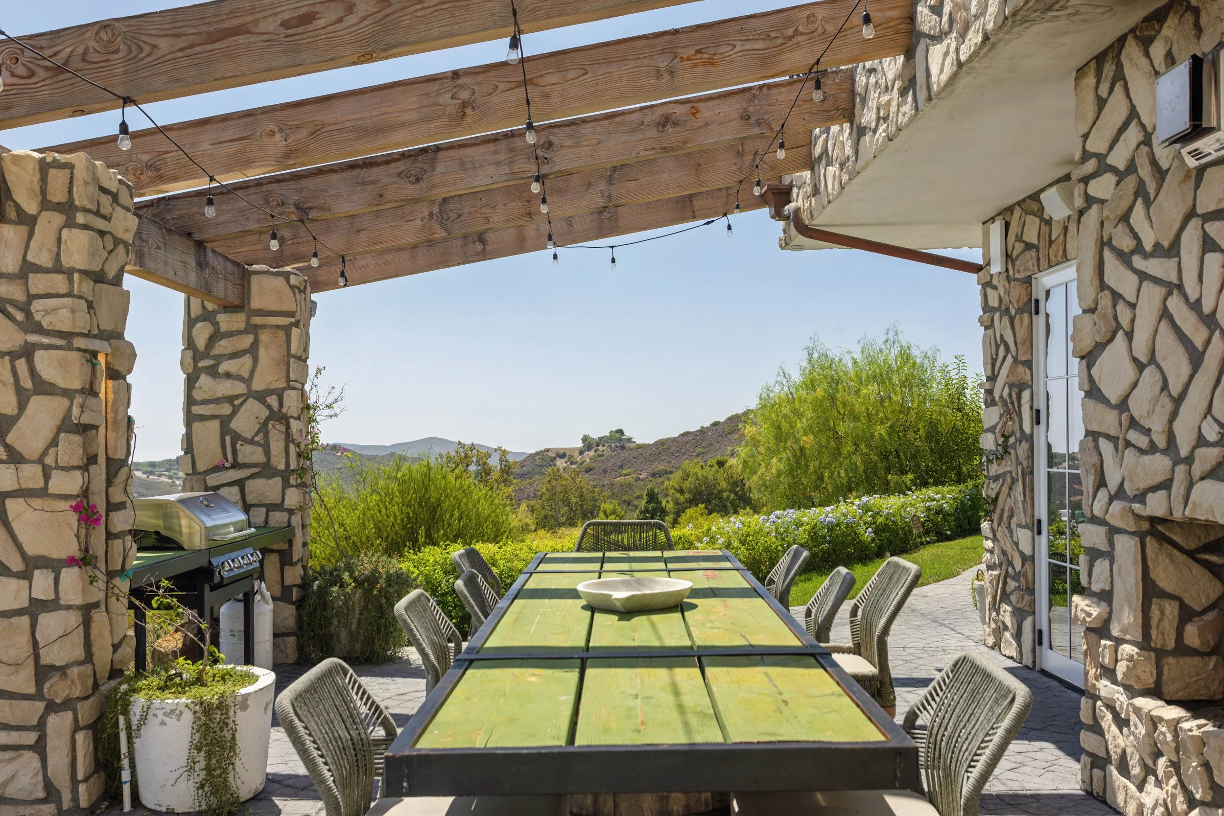malibu-mediterranean-villa-stone-loggia-communal-table.jpg