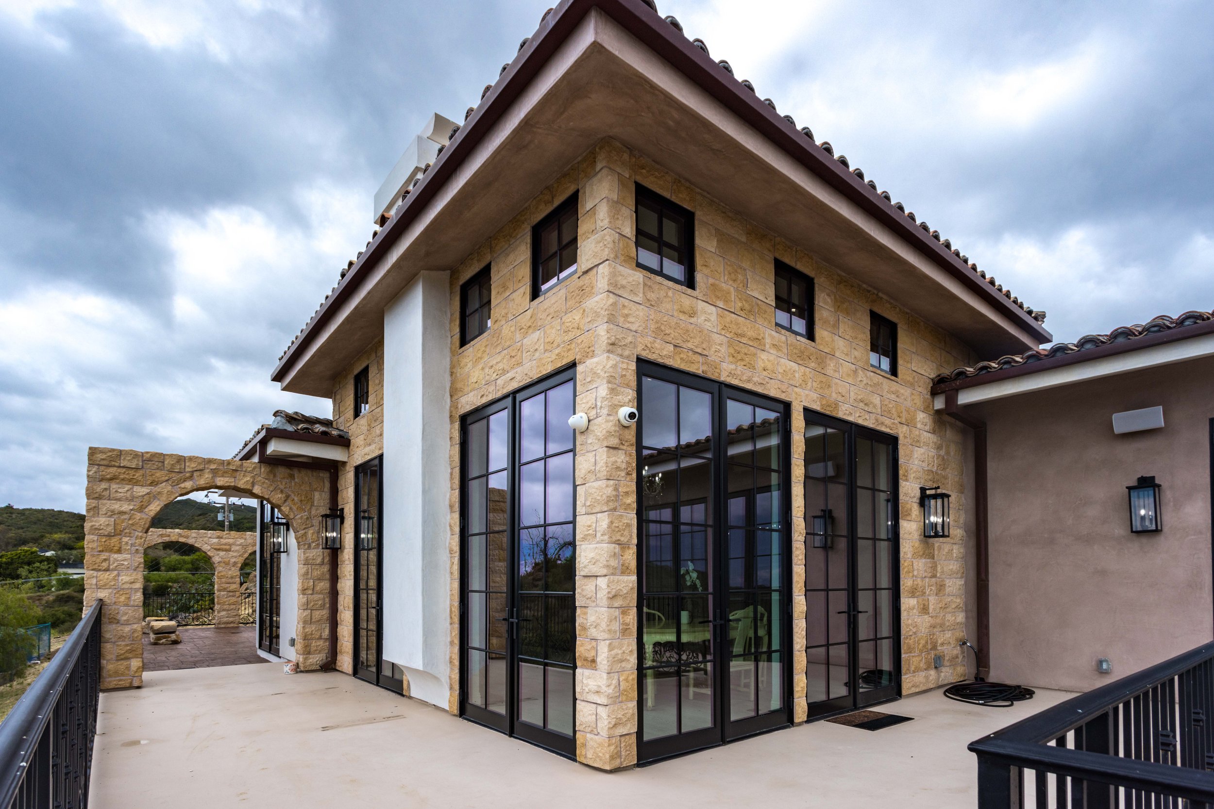 malibu-mediterranean-estate-stone-french-doors-archway.jpg