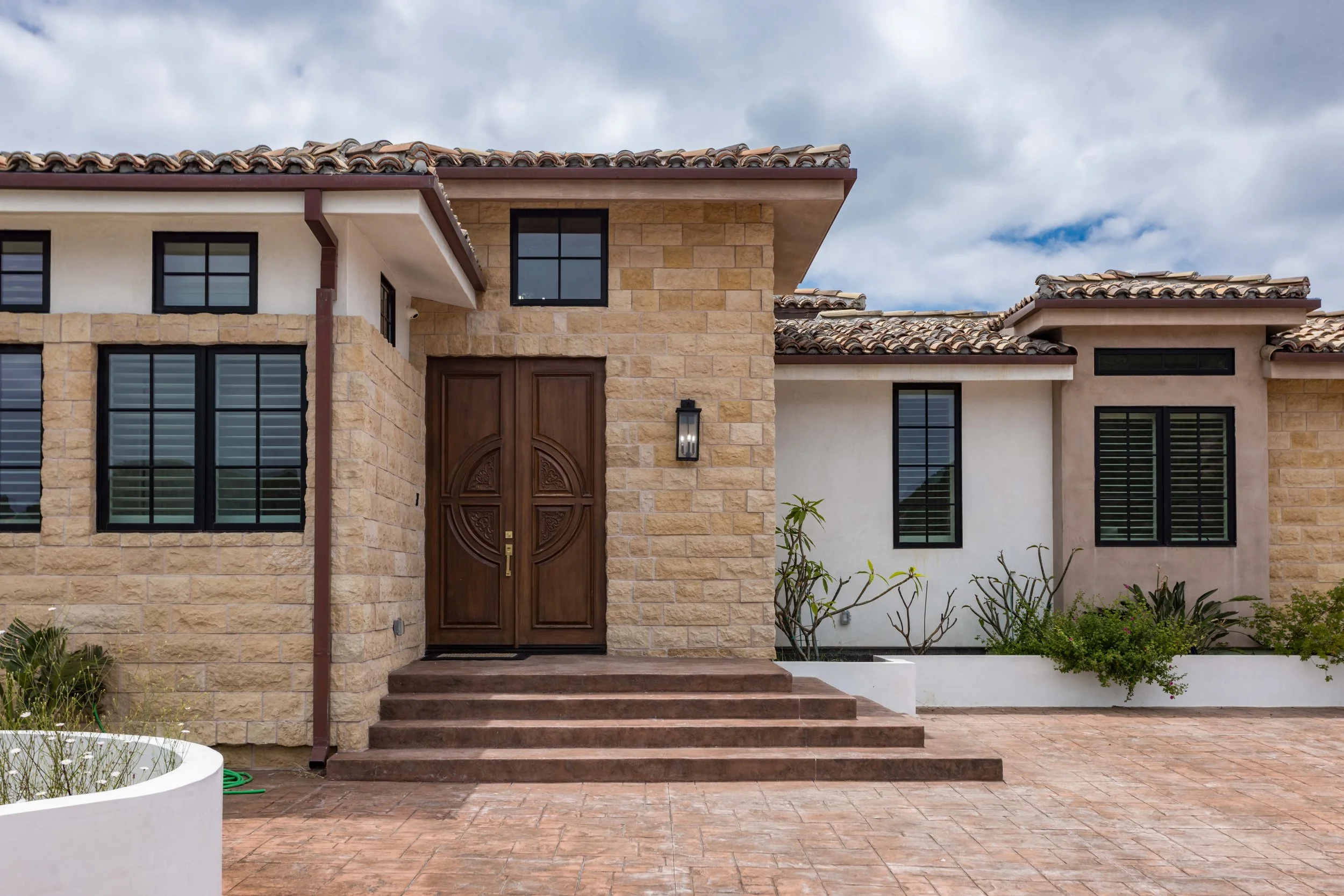 malibu-mediterranean-estate-stone-facade-front-door.jpg
