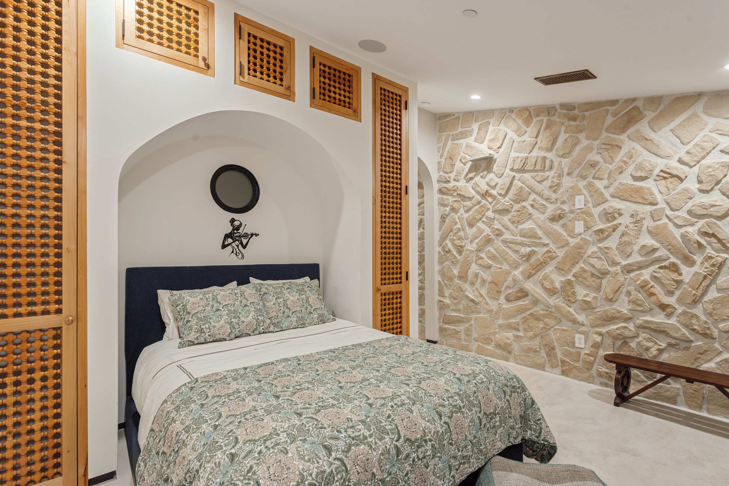 malibu-mediterranean-villa-bedroom-stone-arched-niche.jpg