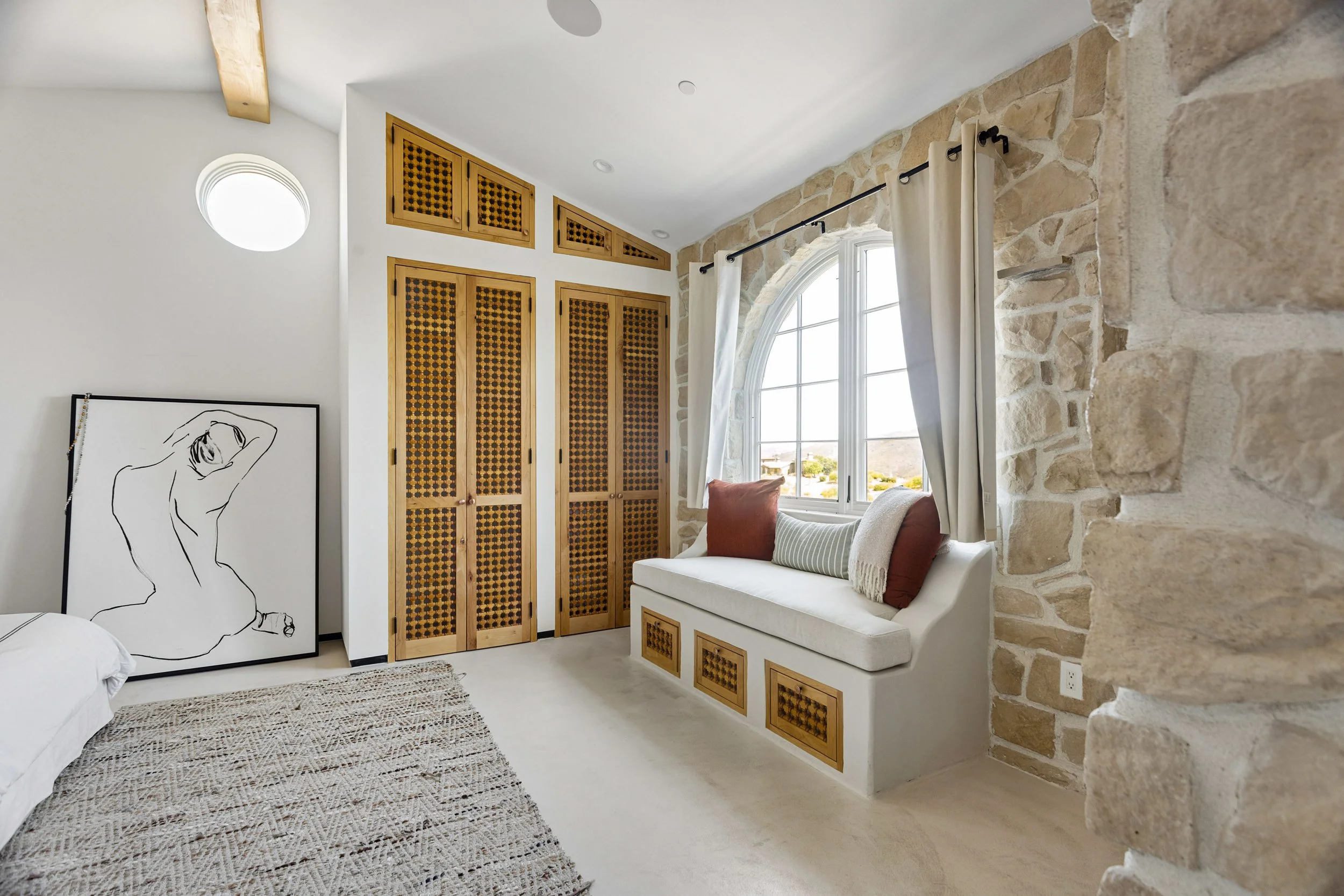 malibu-mediterranean-villa-bedroom-stone-window-seat.jpg