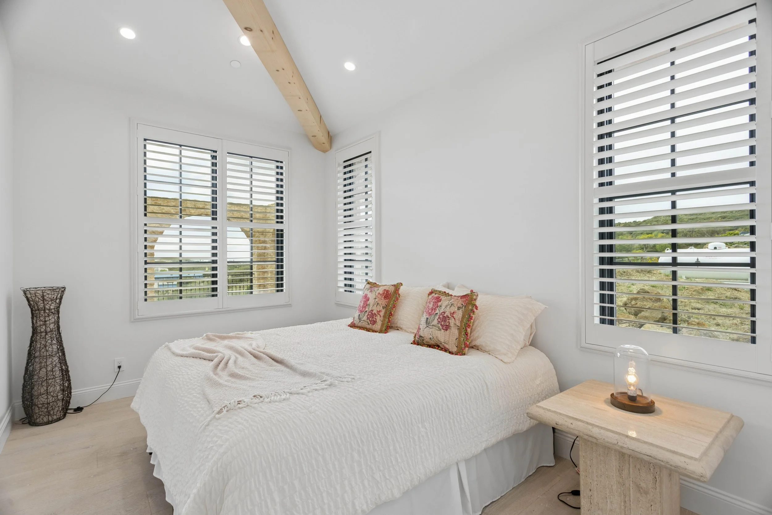malibu-luxury-home-bright-bedroom-exposed-wood-beam.jpg