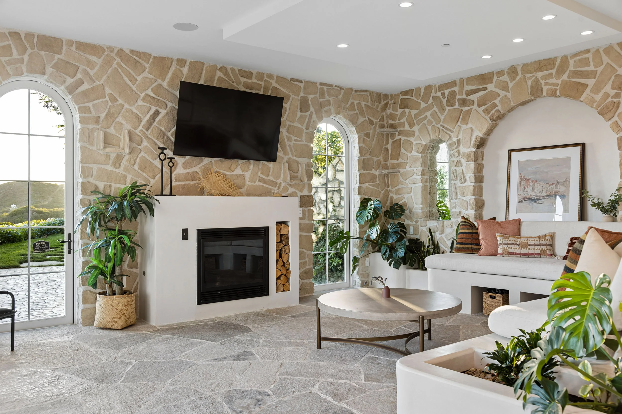 malibu-mediterranean-villa-stone-living-fireplace.jpg