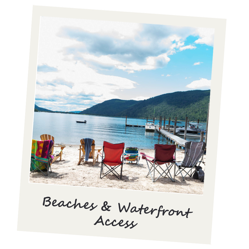 A beach with several colorful chairs facing a waterfront with boats and a pier, surrounded by hills and a partly cloudy sky.