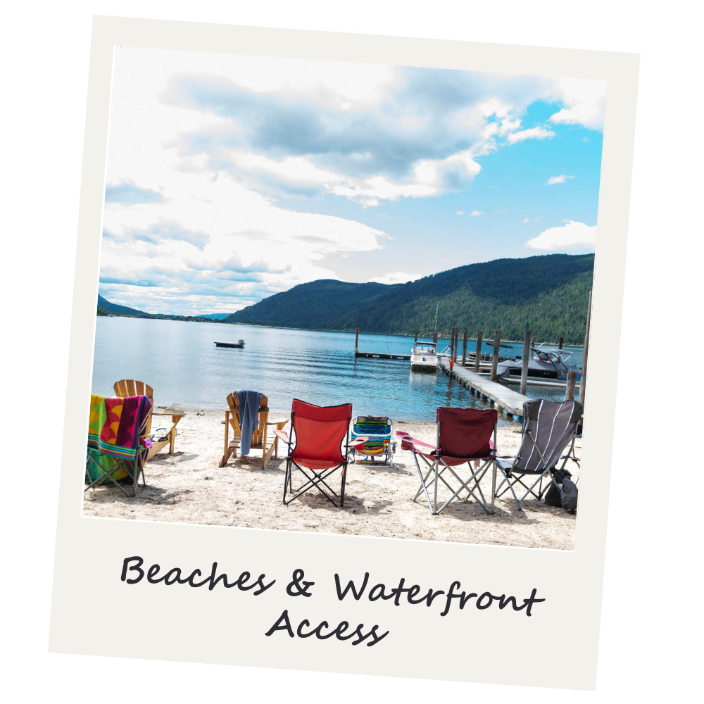 A beach with several colorful chairs facing a waterfront with boats and a pier, surrounded by hills and a partly cloudy sky.