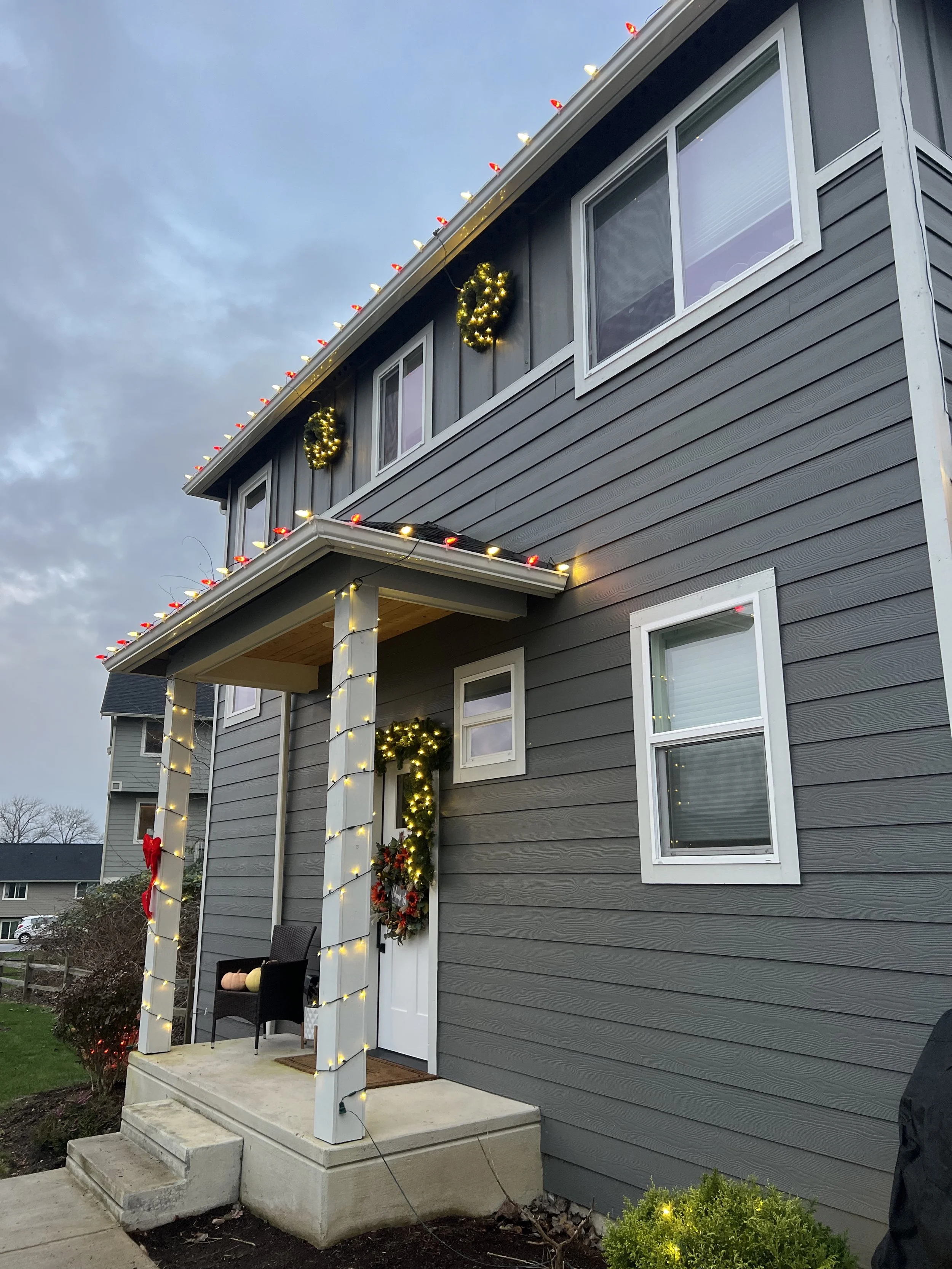 Candycane color pattern with multiple LED lit wreaths and Garland over door